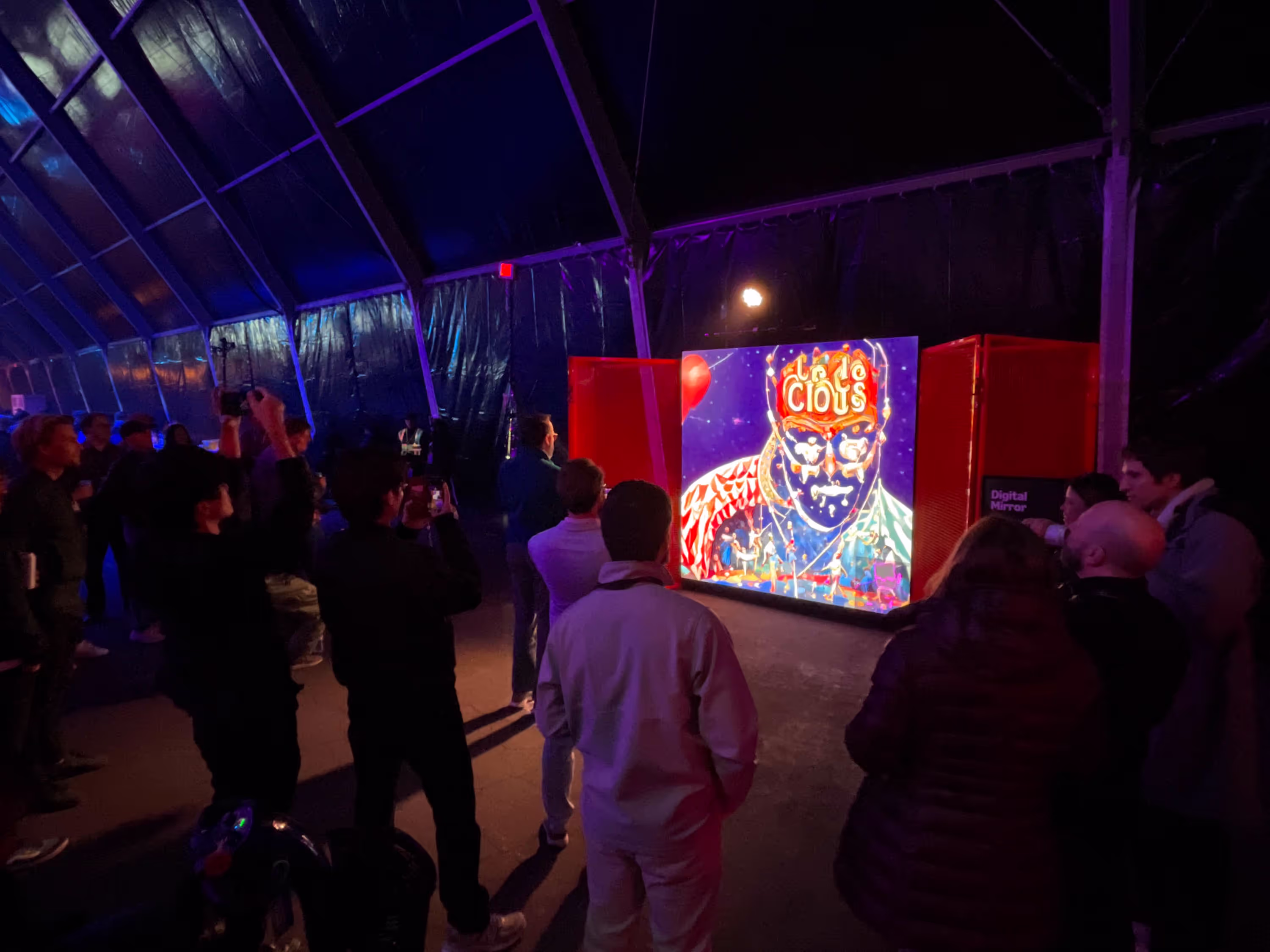 People standing in front of a large screen