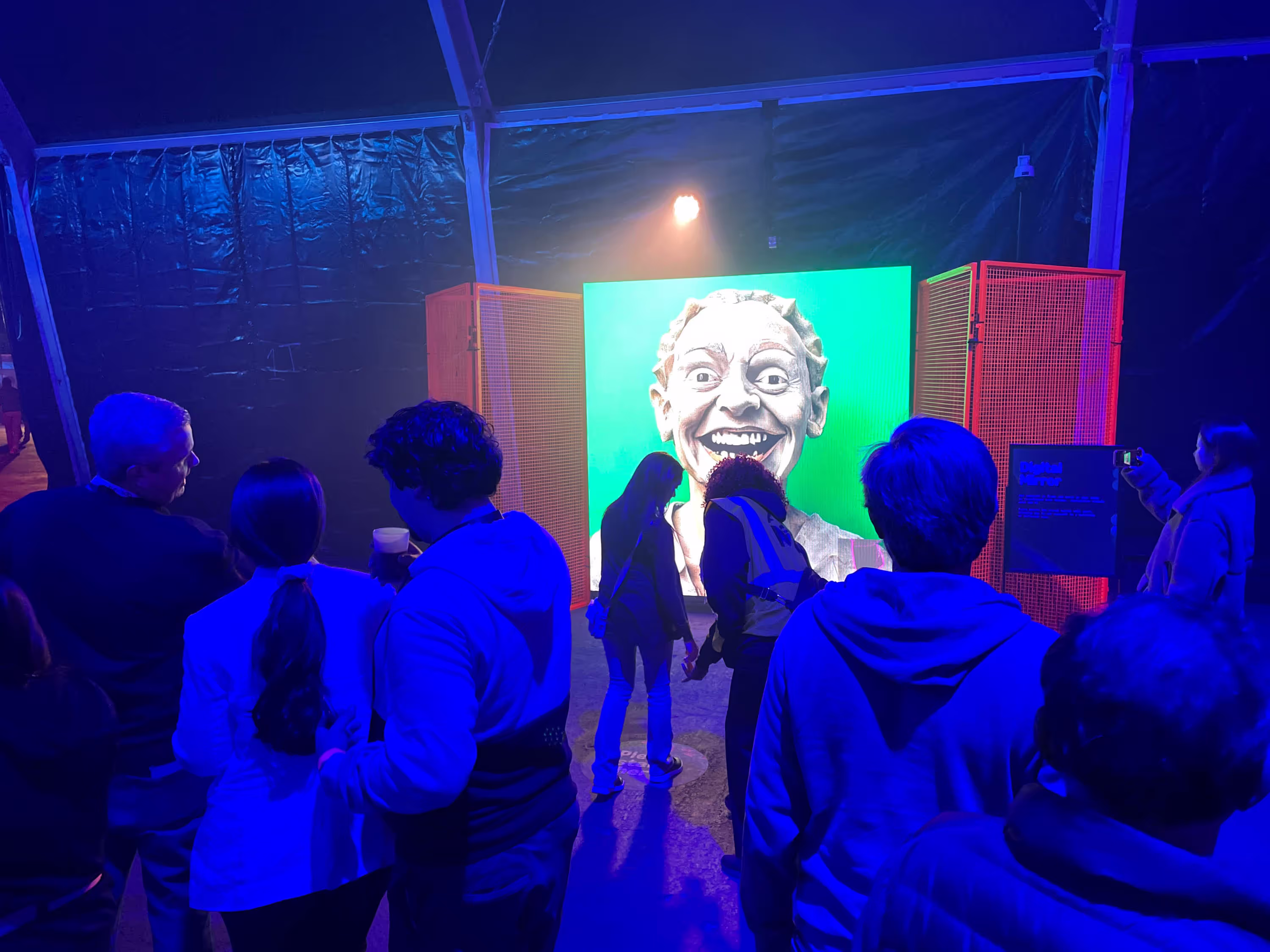People standing in front of a large screen