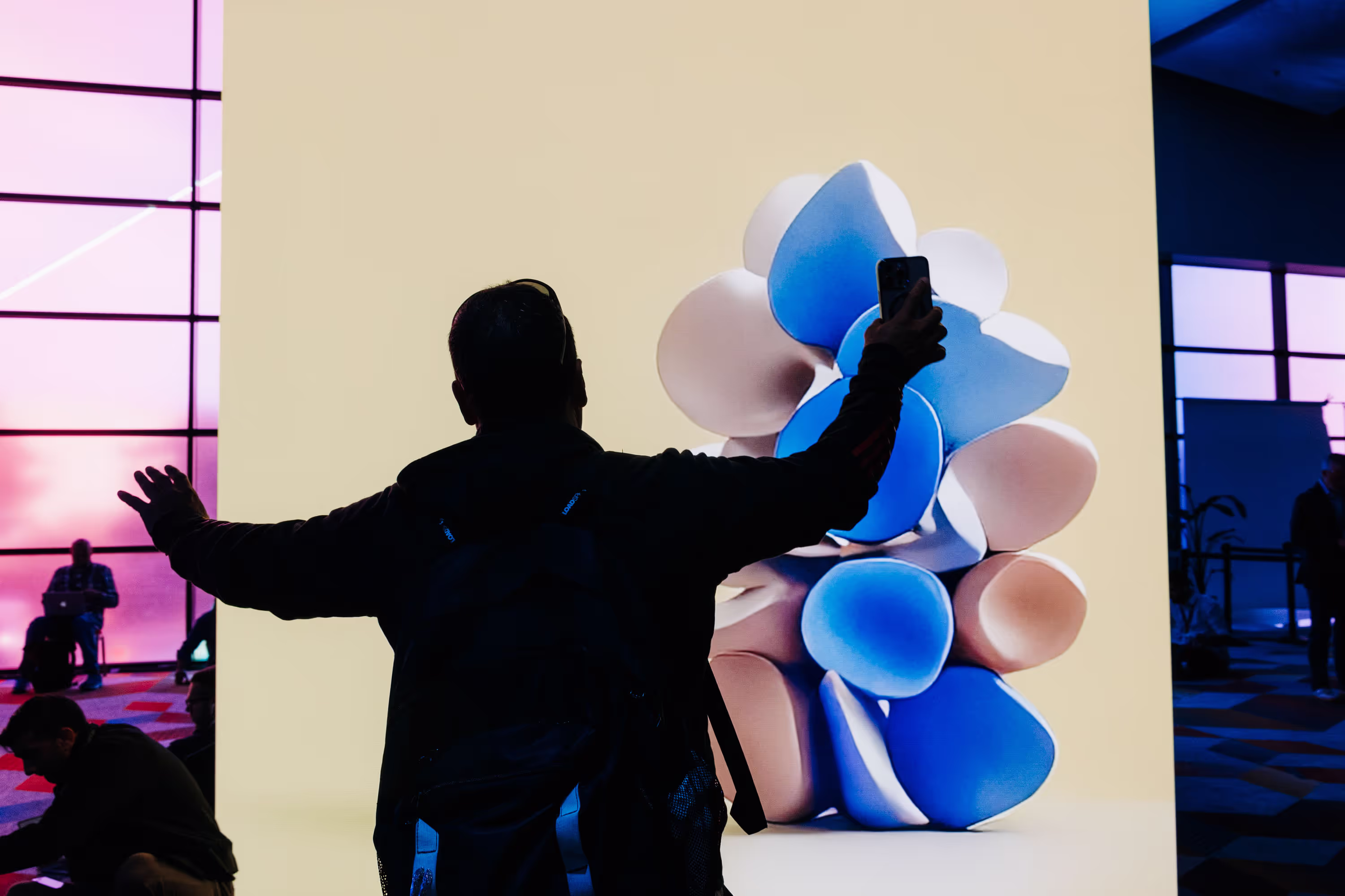 A man taking a picture of a large sculpture