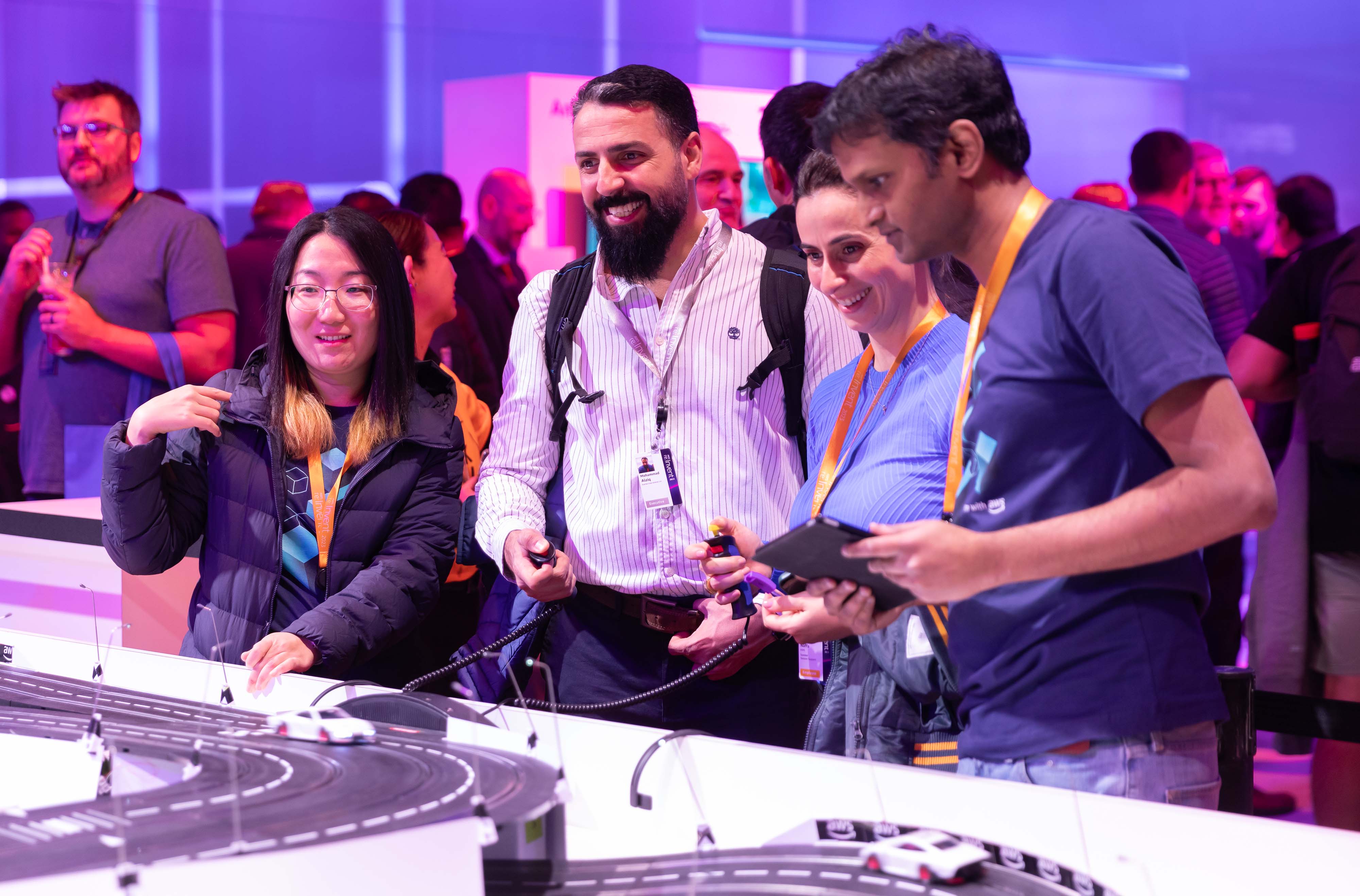 attendees playing with remote control race cars at a conference