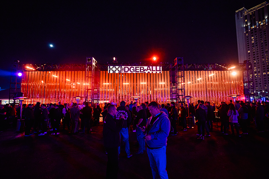 The Dodgeball arena at AWS re:Play 2023, its slatted facade lit orange with guests gathered outside