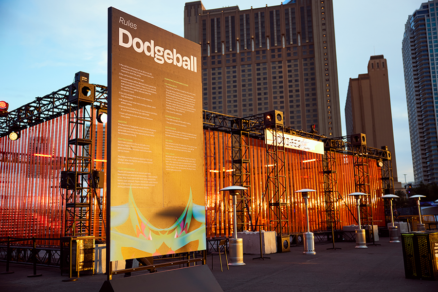 The printed Dodgeball rules board outside the arena at dusk
