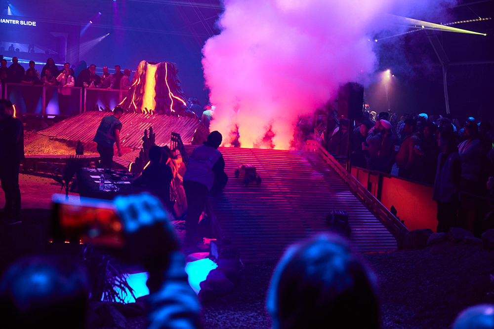Guests filming the RC Racers course as pink smoke drifts across it