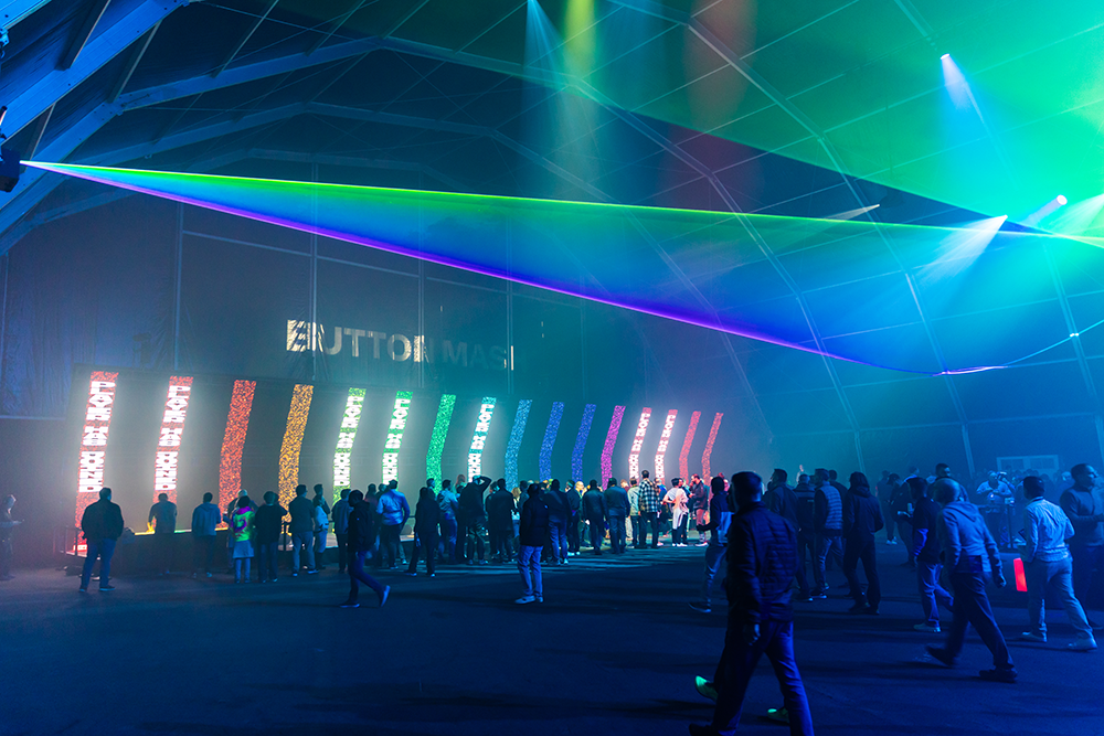 The Button Mash tent from outside with the crowd queueing in haze