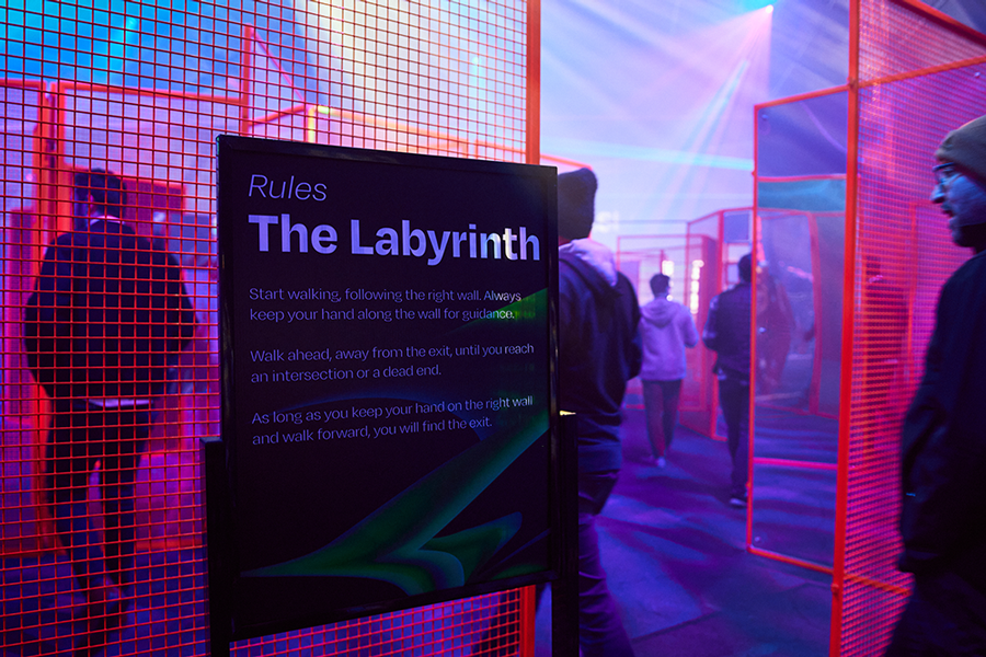 The printed Labyrinth rules board beside the red mesh maze walls