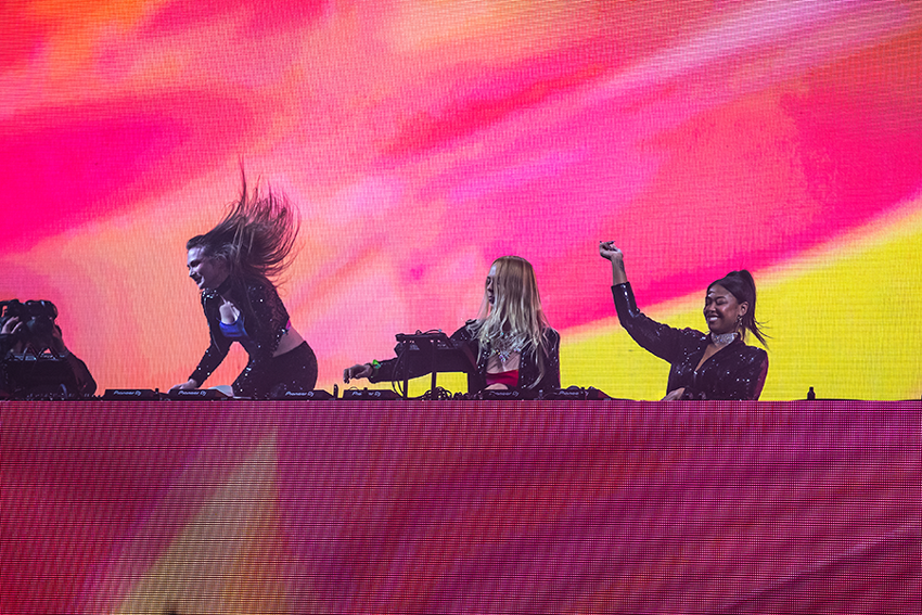 A group of women standing on top of a stage.