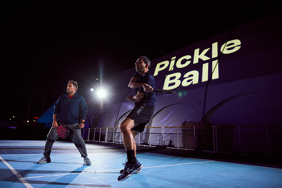 A couple of men standing on top of a tennis court.