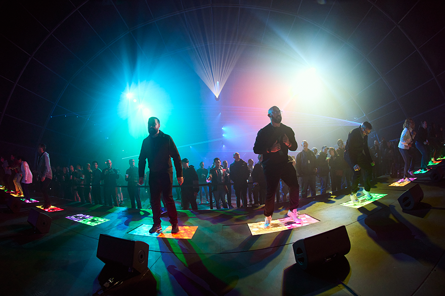 A group of people standing on top of a stage.
