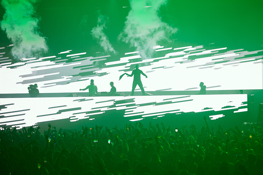A group of people standing on top of a stage.