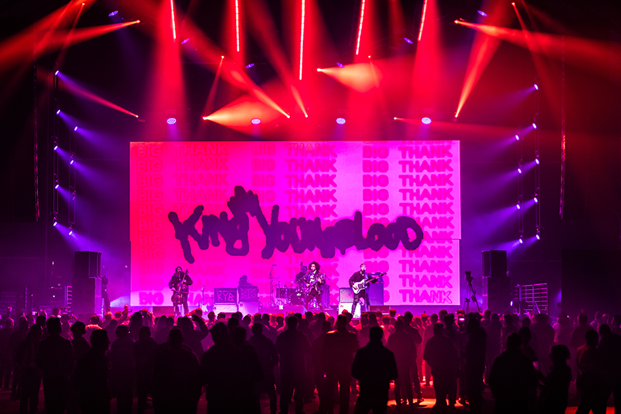 A group of people standing on top of a stage.