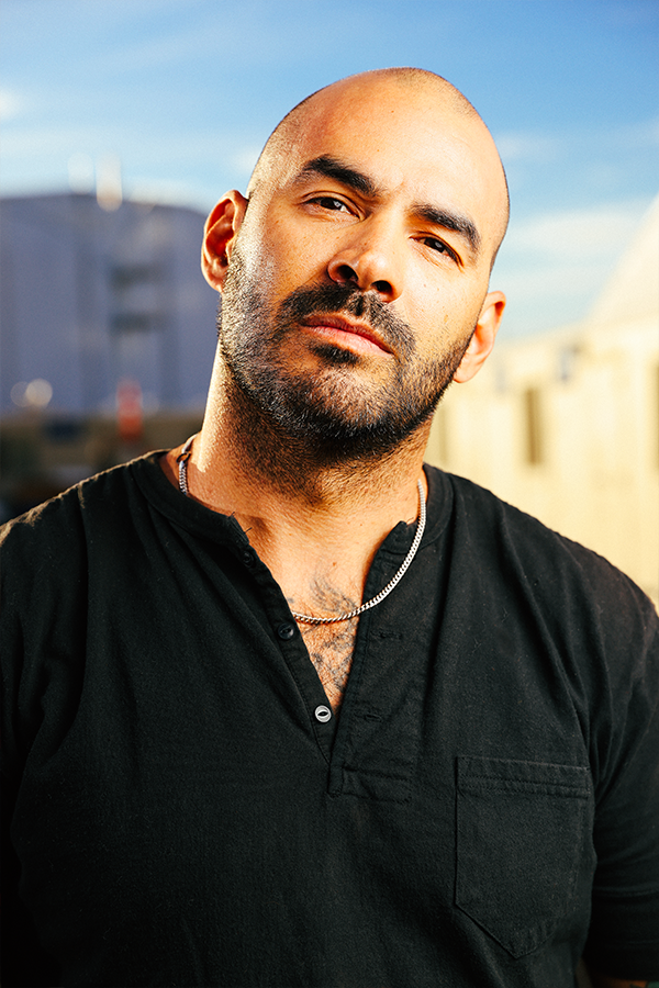 A man with a bald head wearing a black shirt.