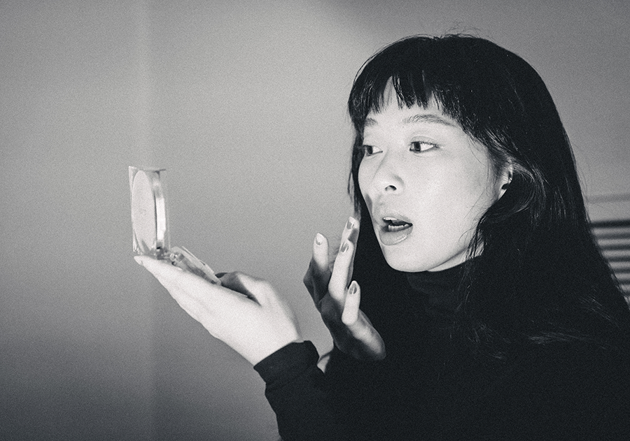 A woman holding a mirror in her hands.