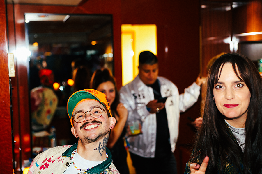 A man with a mustache and a woman with a green hat.