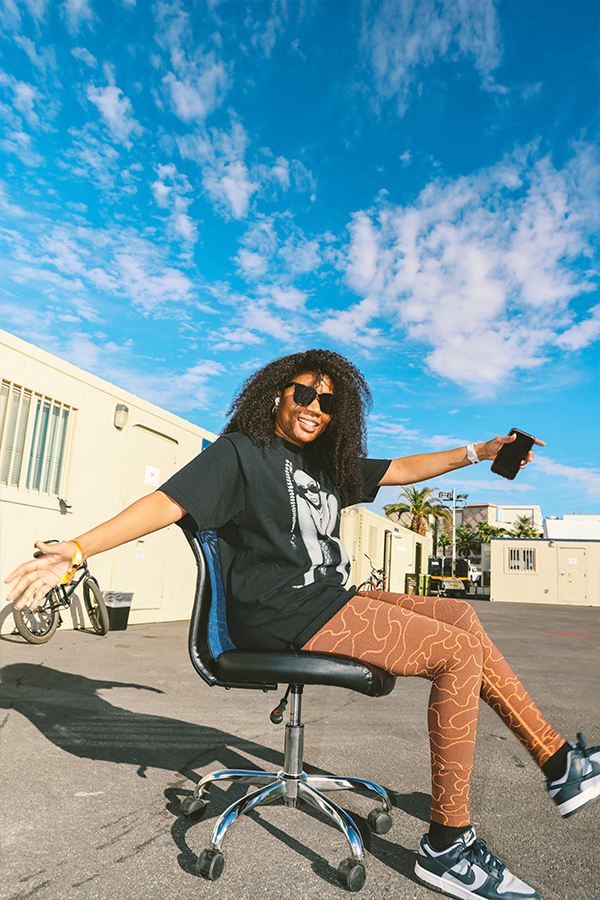 A woman sitting on top of an office chair.