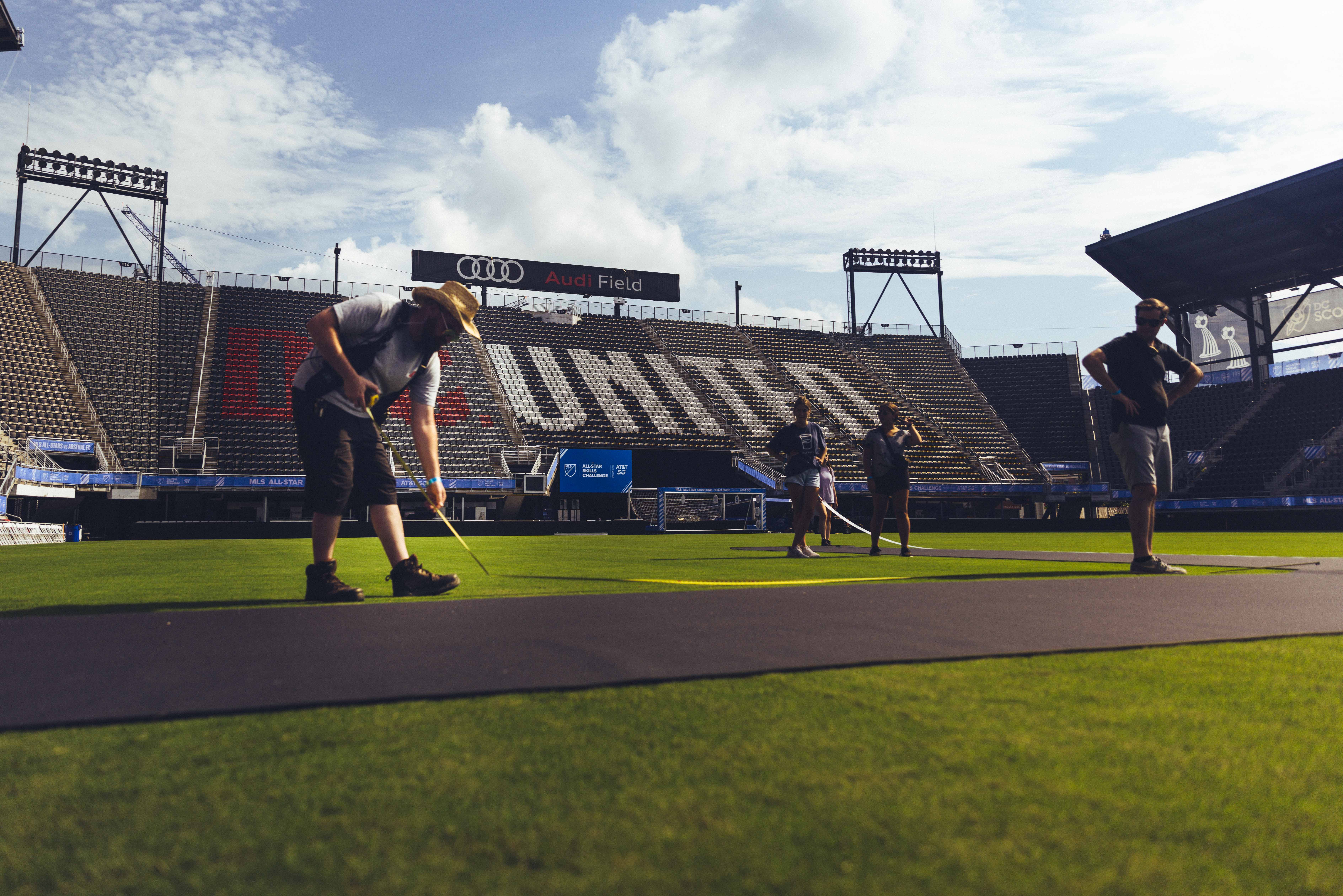 a person walking across a stadium before the game starts