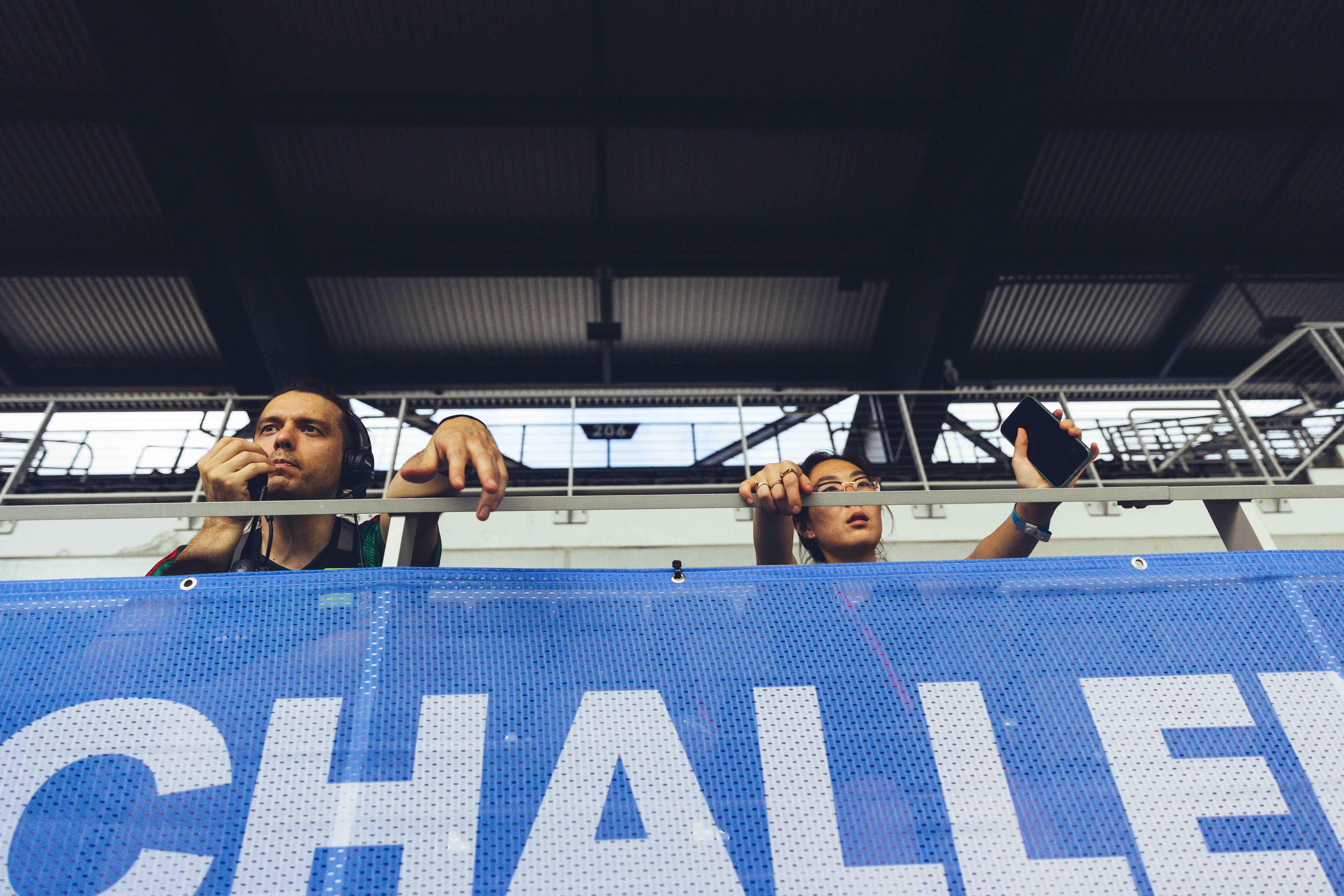 two people overlooking a blue banner with text on it
