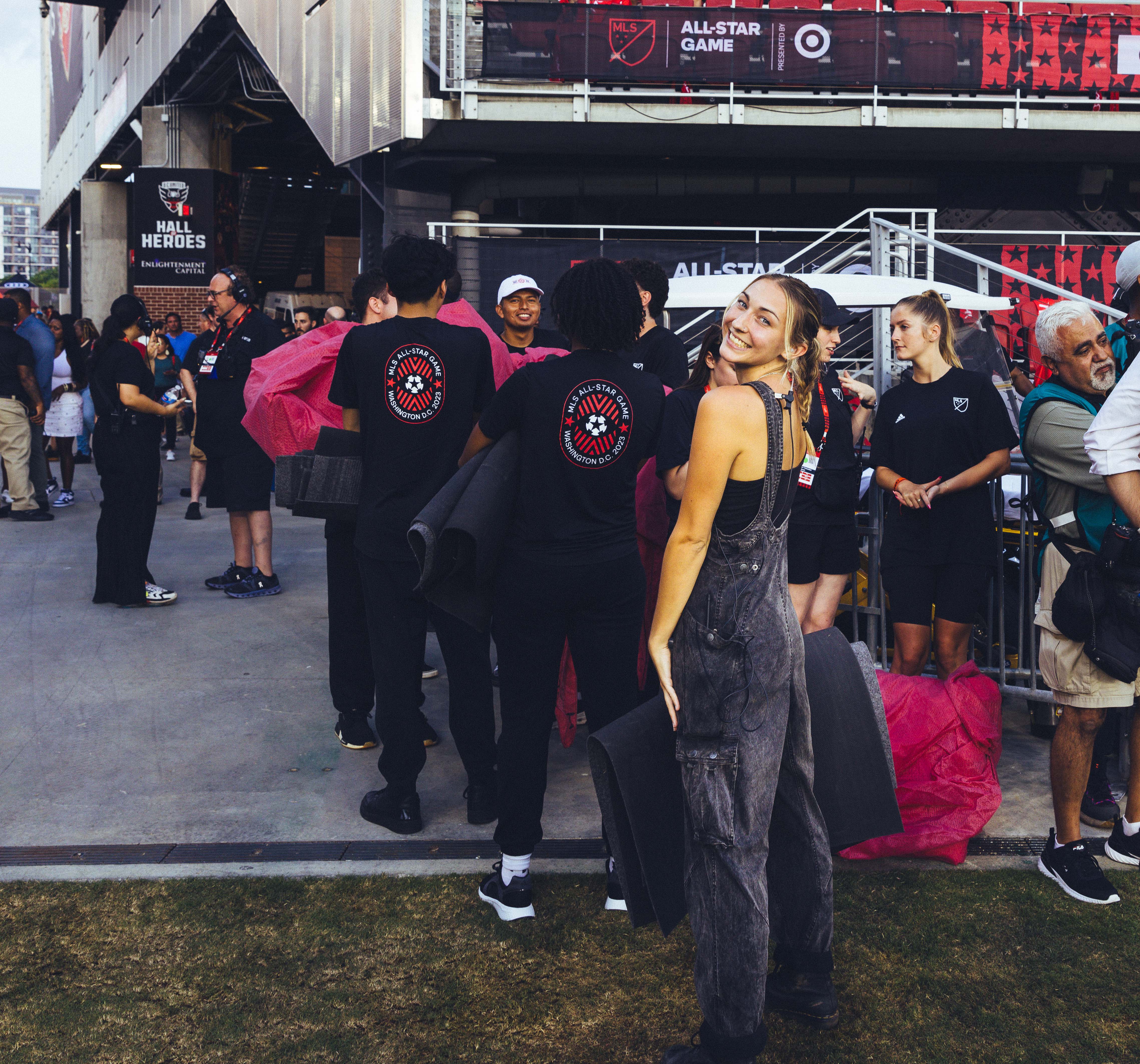 group of people dressed in black and red clothing outside