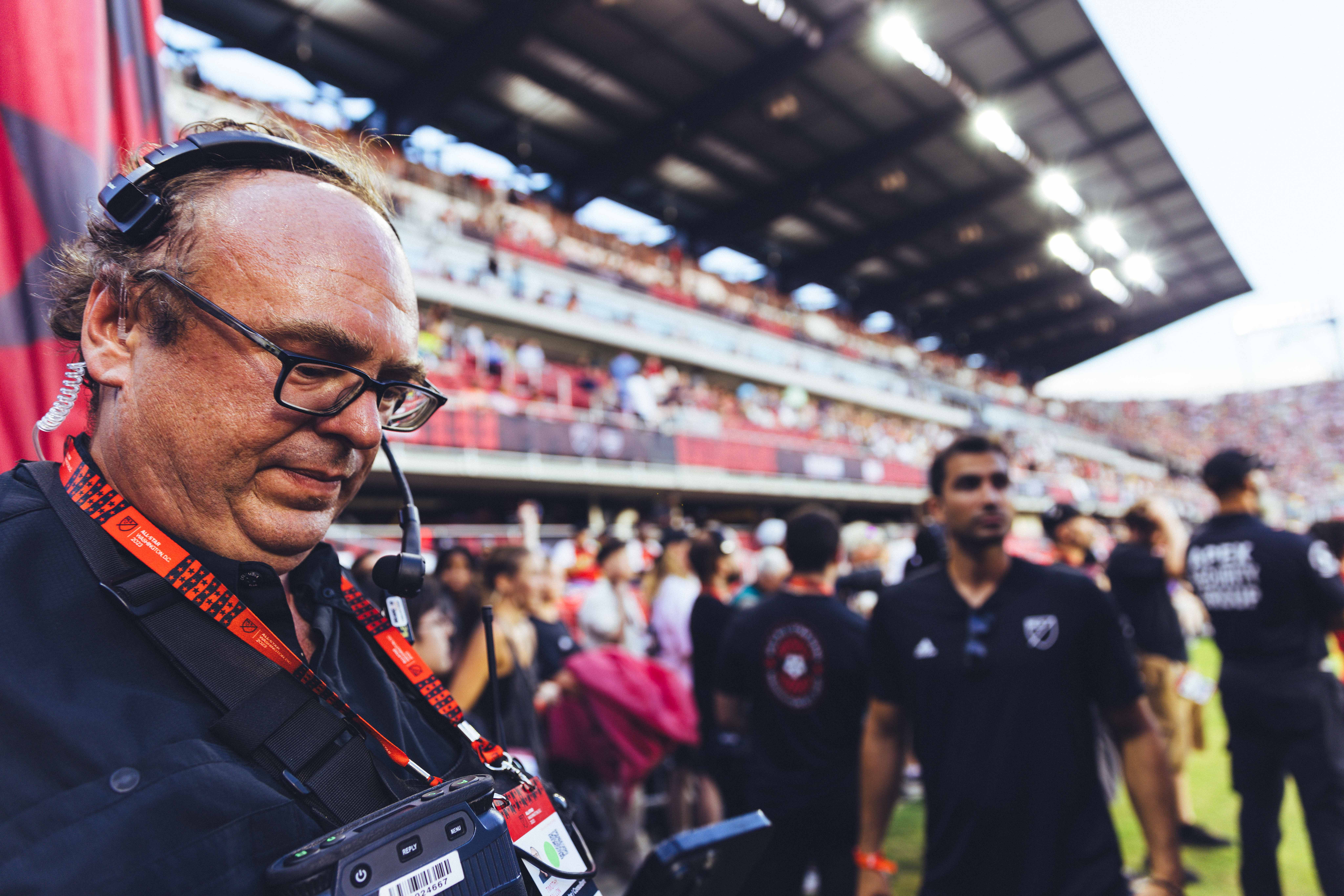 man on soccer field with headset
