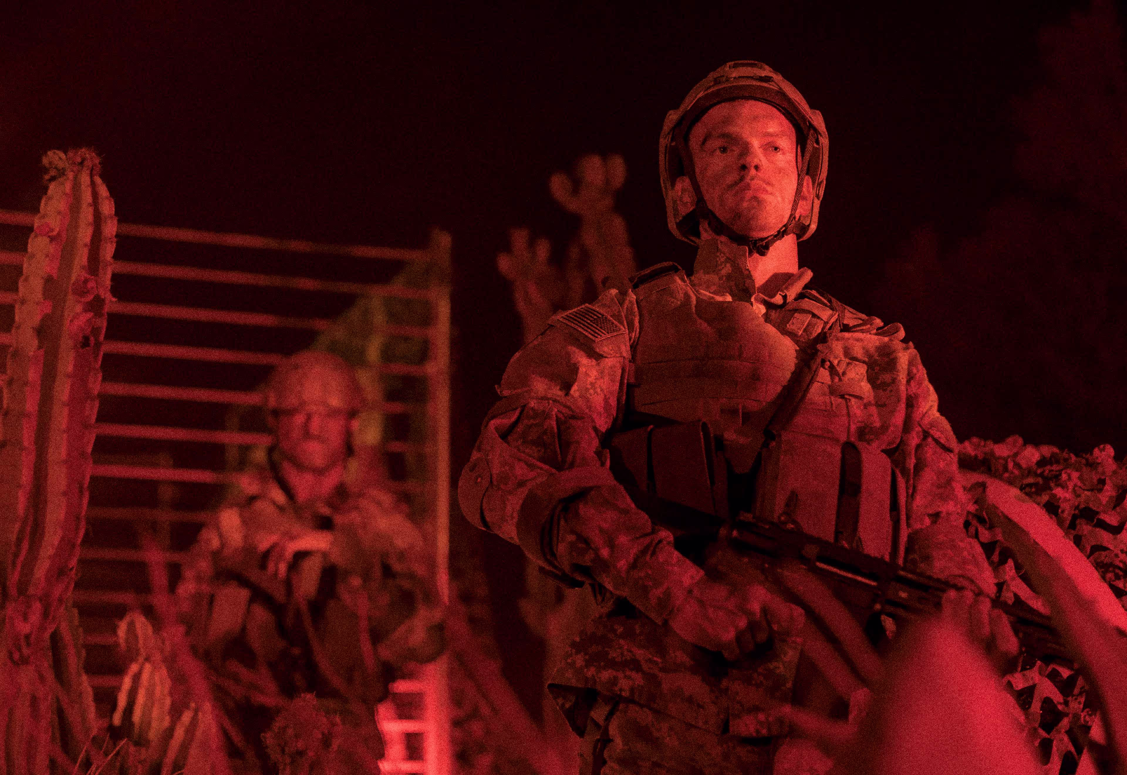 man dressed in a military uniform with red lighting
