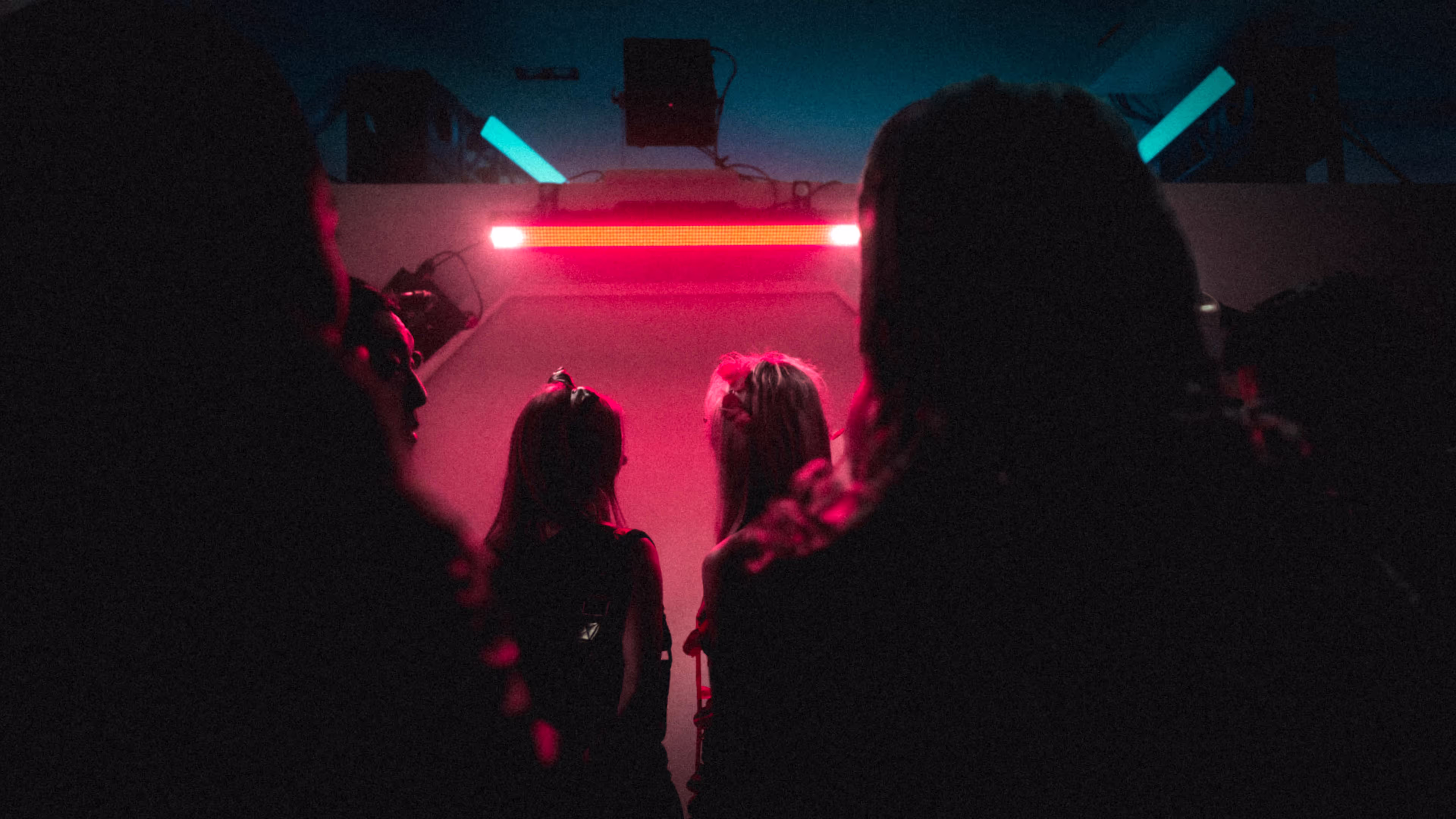 people standing in front of fluorescent red light