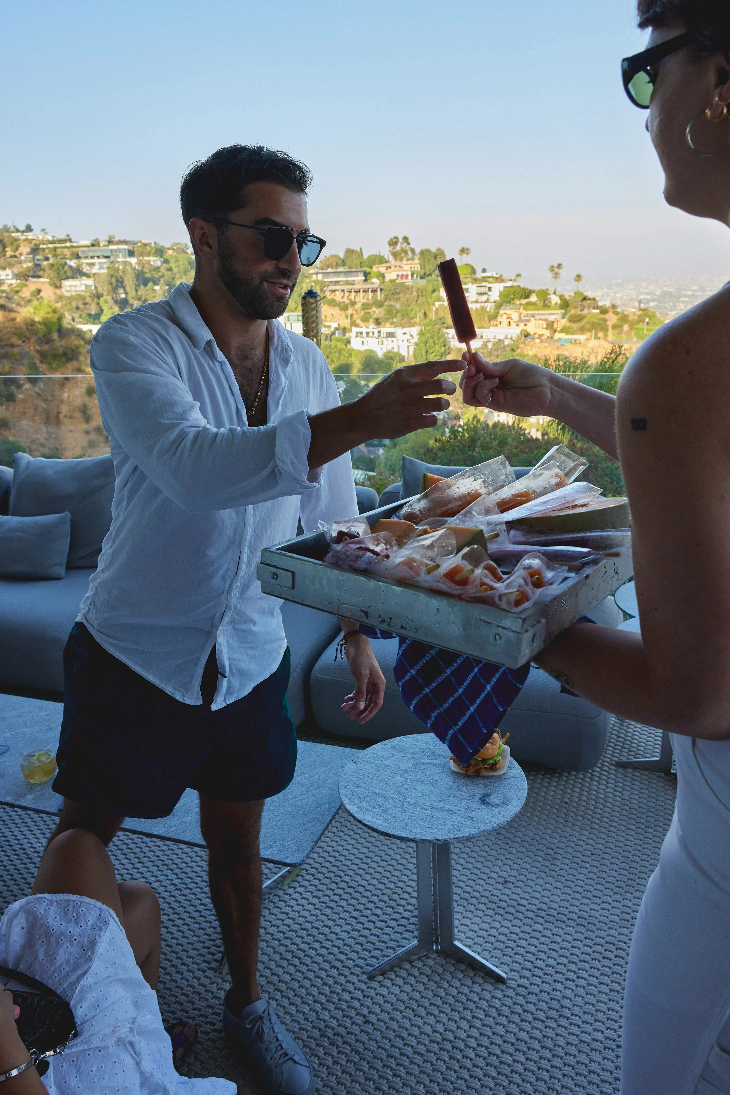 man in white shirt standing on a patio