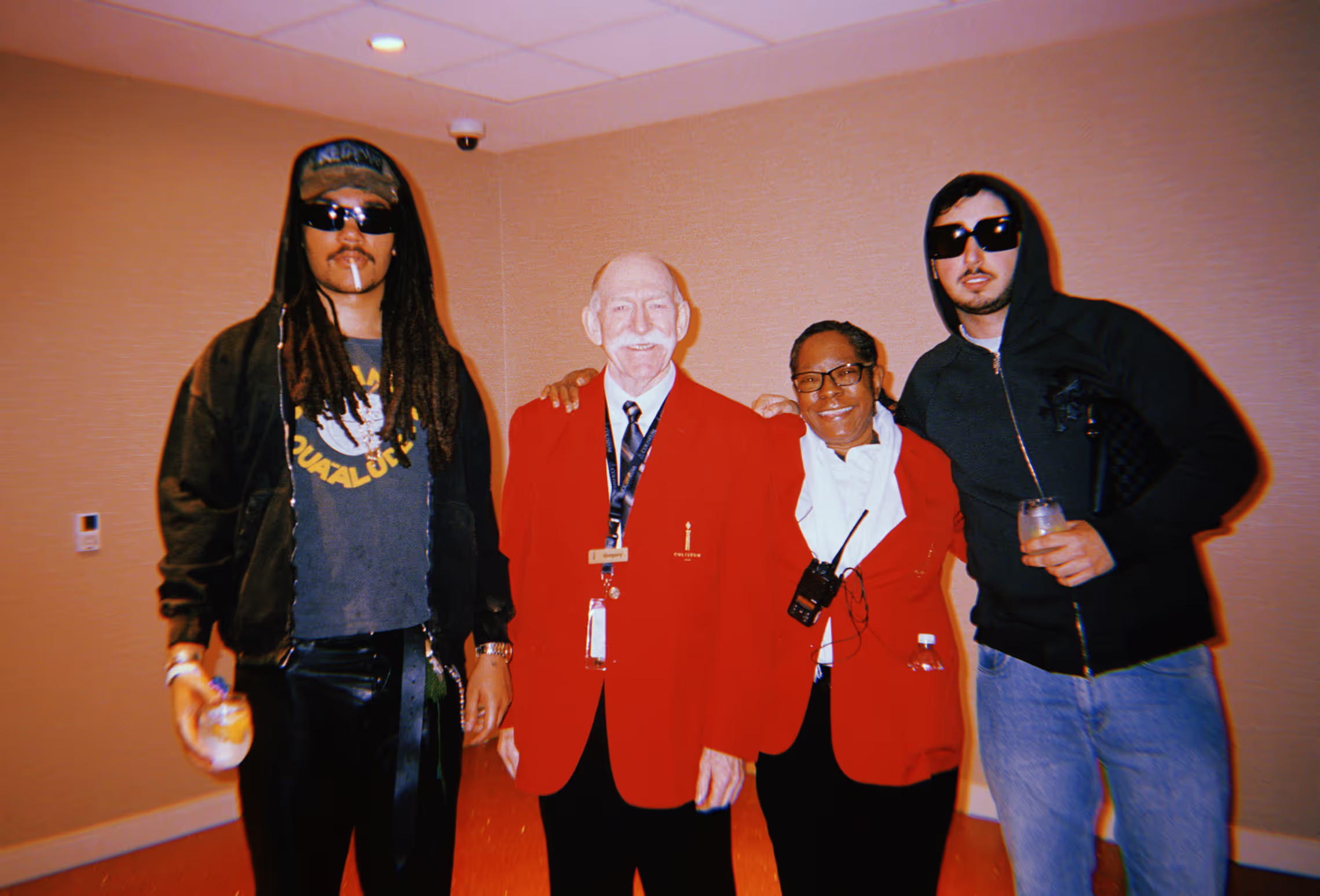 group of men posing together inside of a hallway