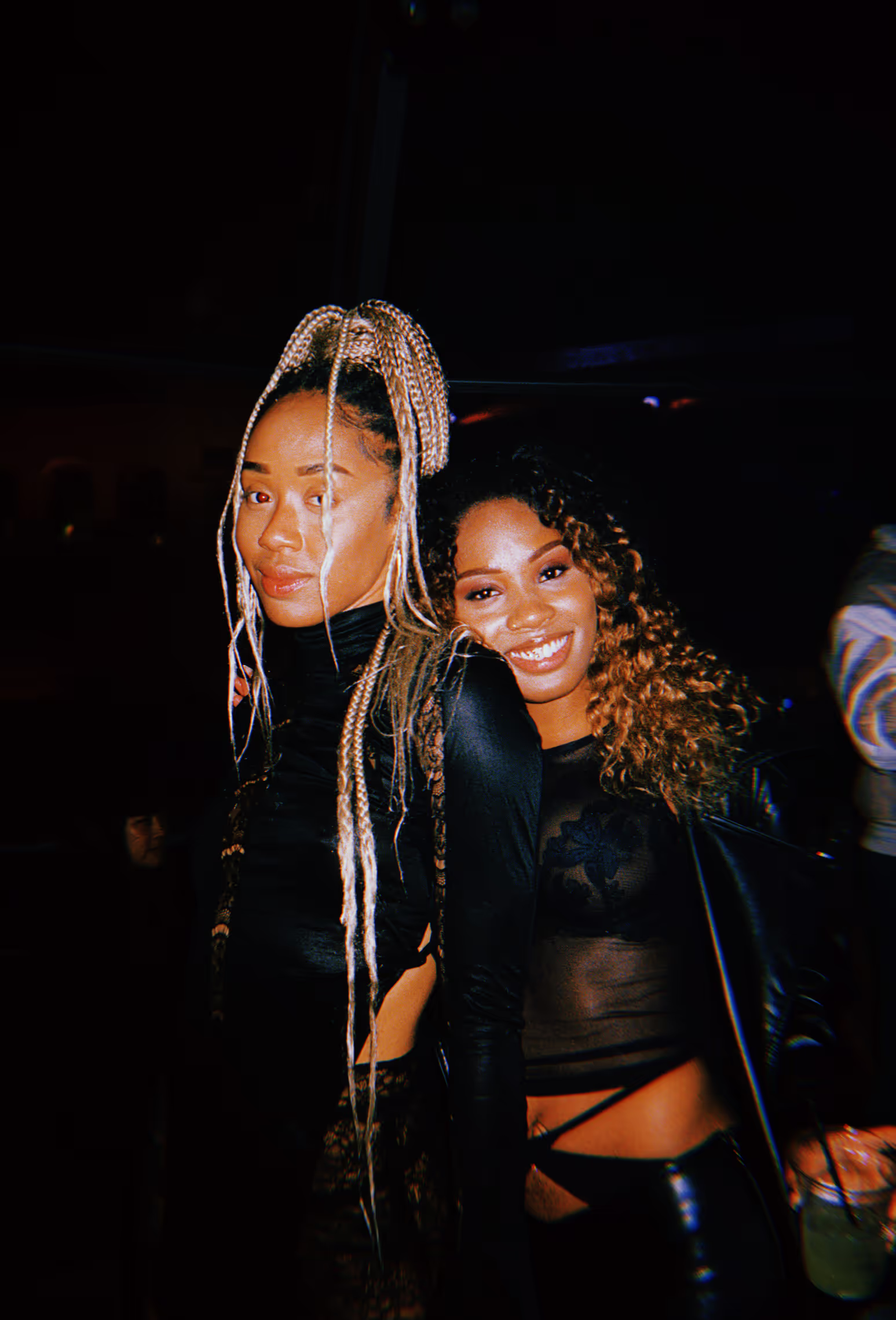 two women dressed in black at a rave