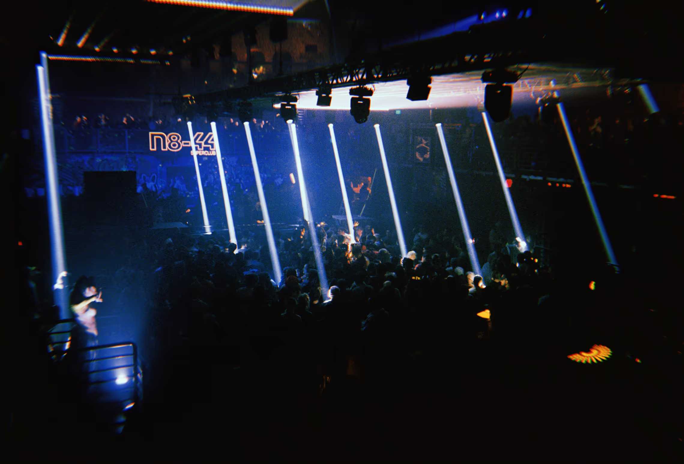 spotlights in a dark rave crowd