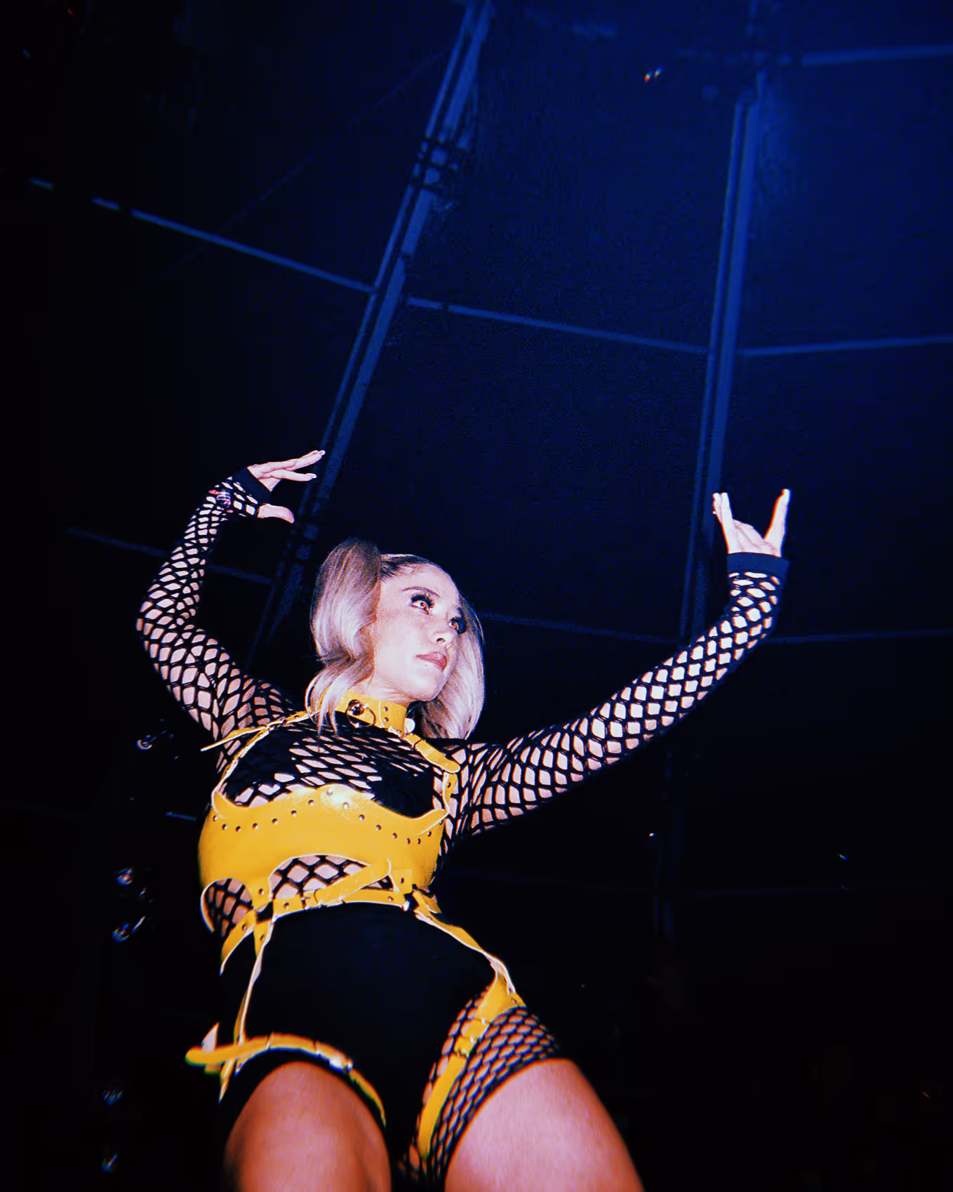dancer wearing black and yellow at a rave