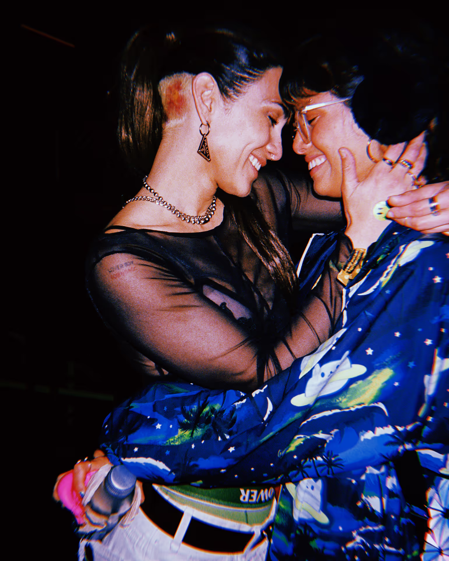 two women embracing at a rave