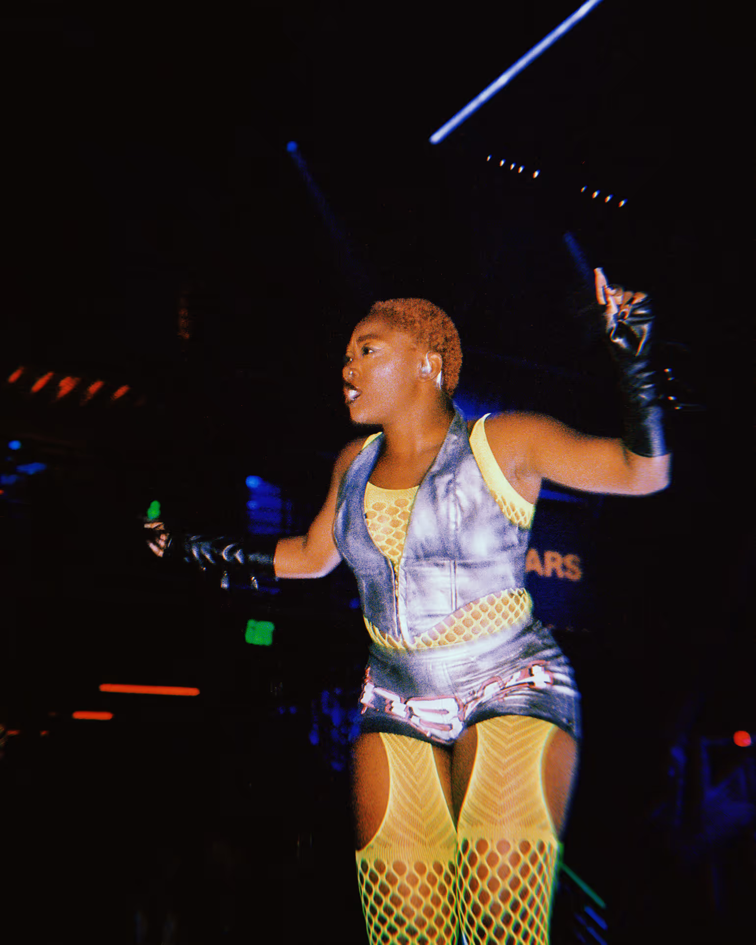 woman in yellow chaps at a rave