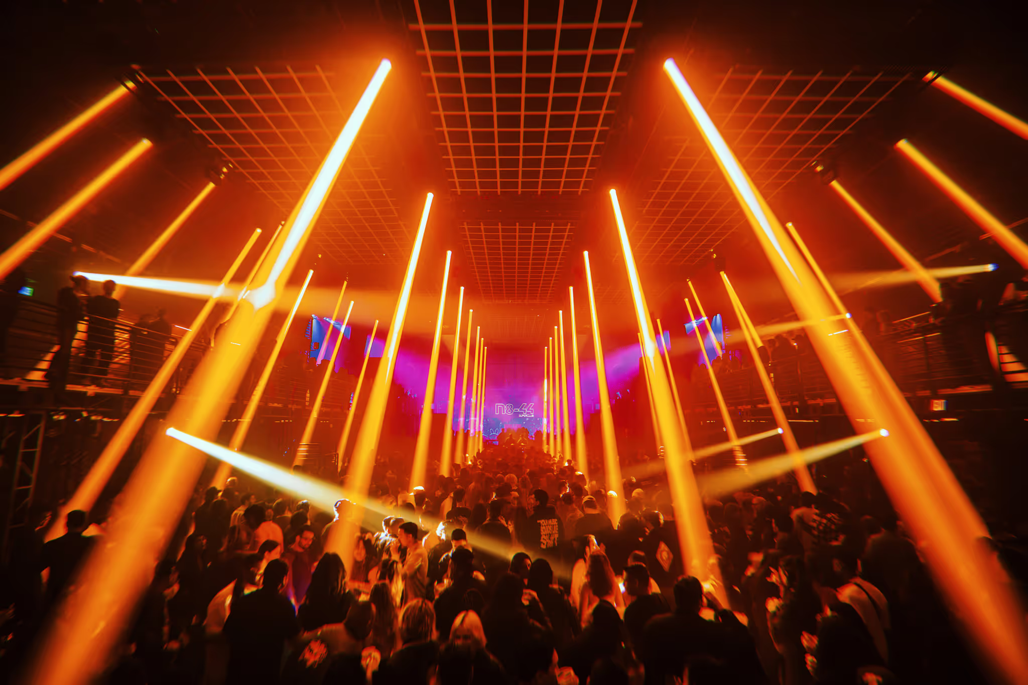 orange laser lighting at an underground rave
