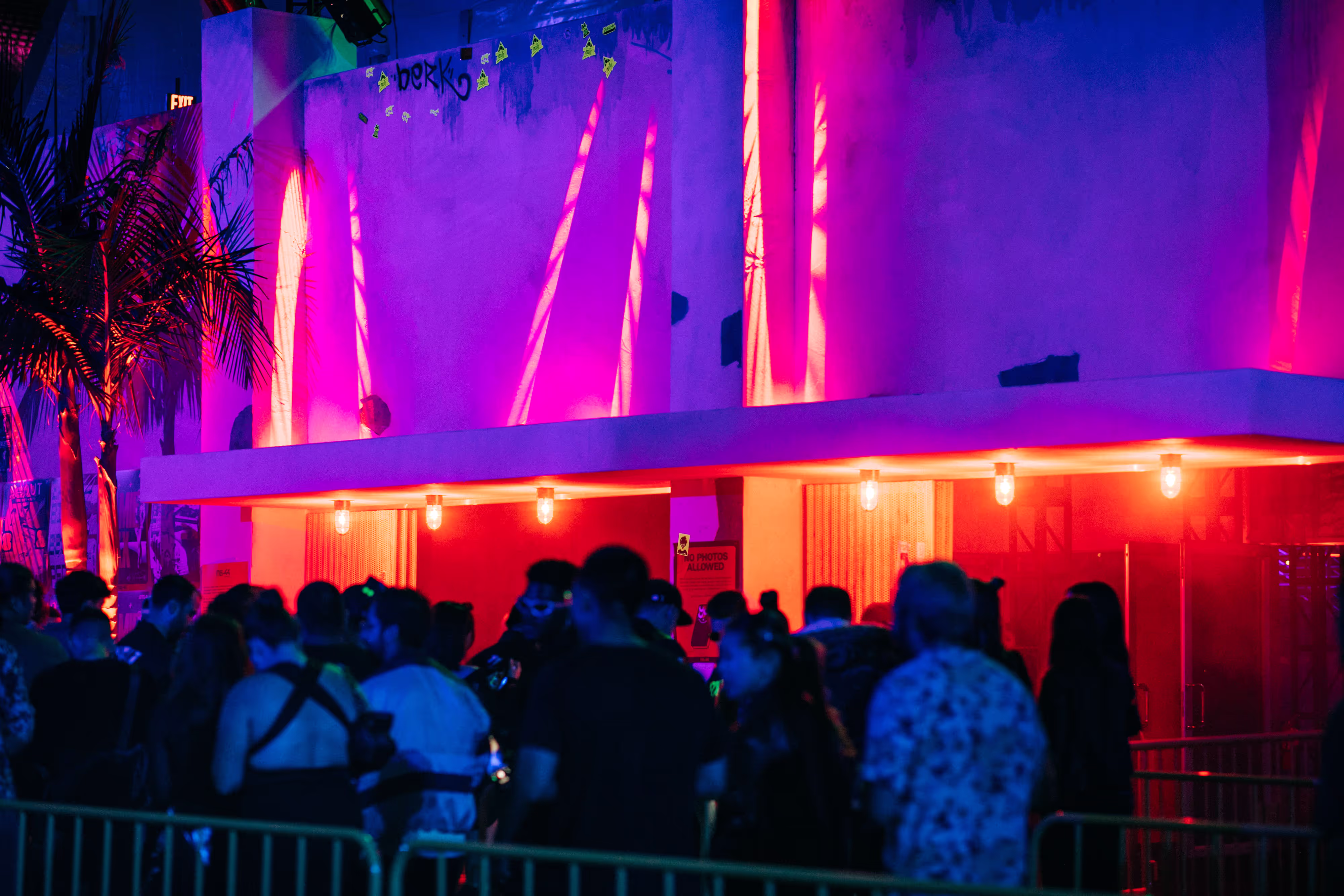 red and purple lighting outside of a rave