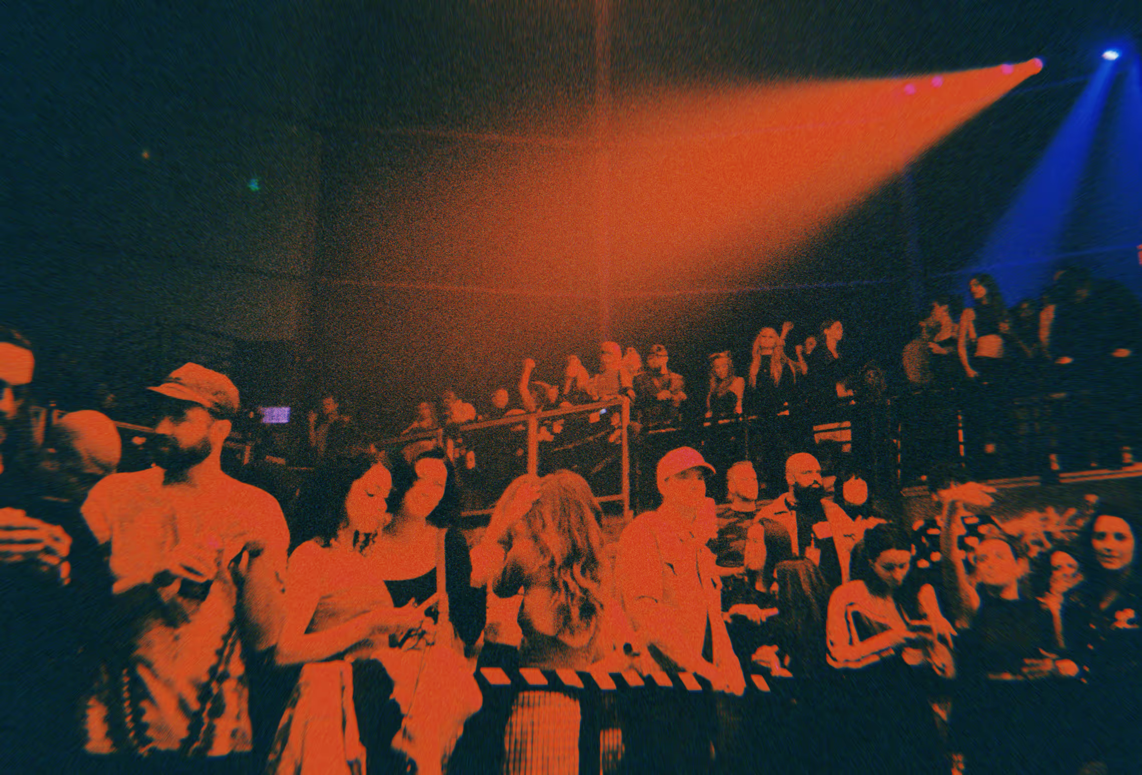 post-processed image of a crowd at a warehouse rave
