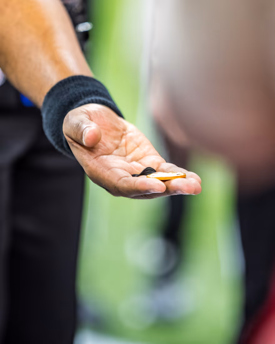 Person holding a coin