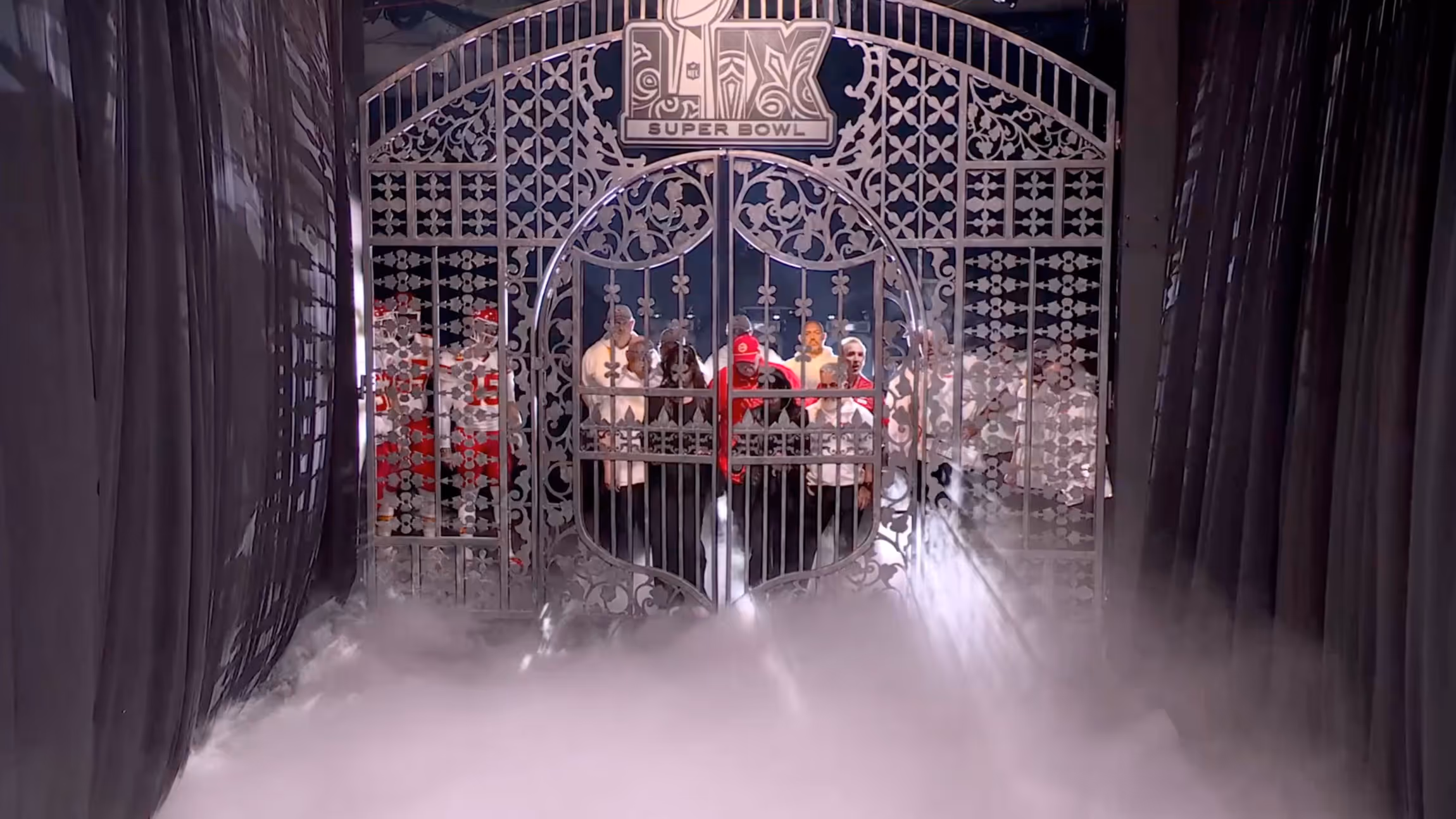 People standing behind a gate