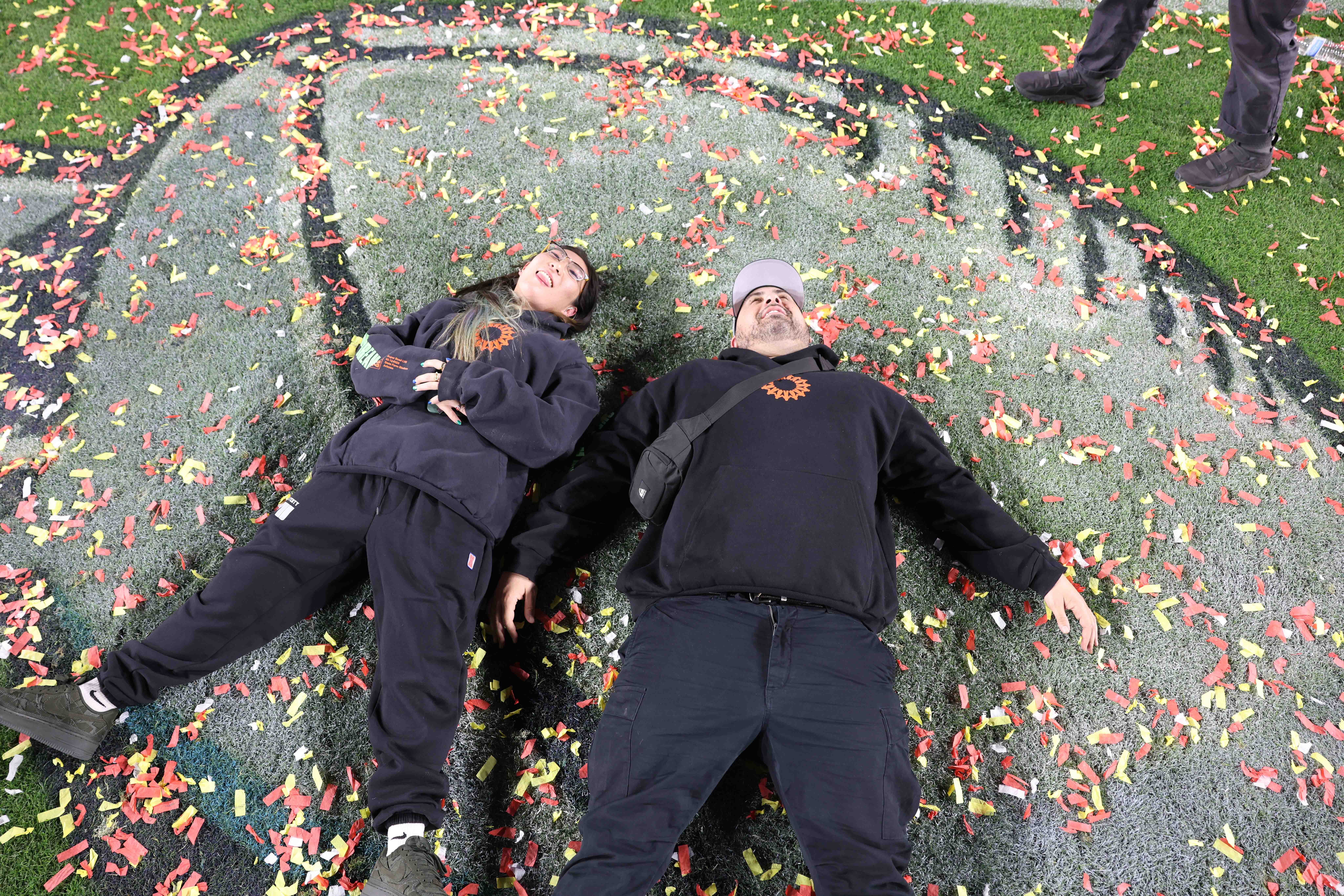 a group of people in a field of flowers
