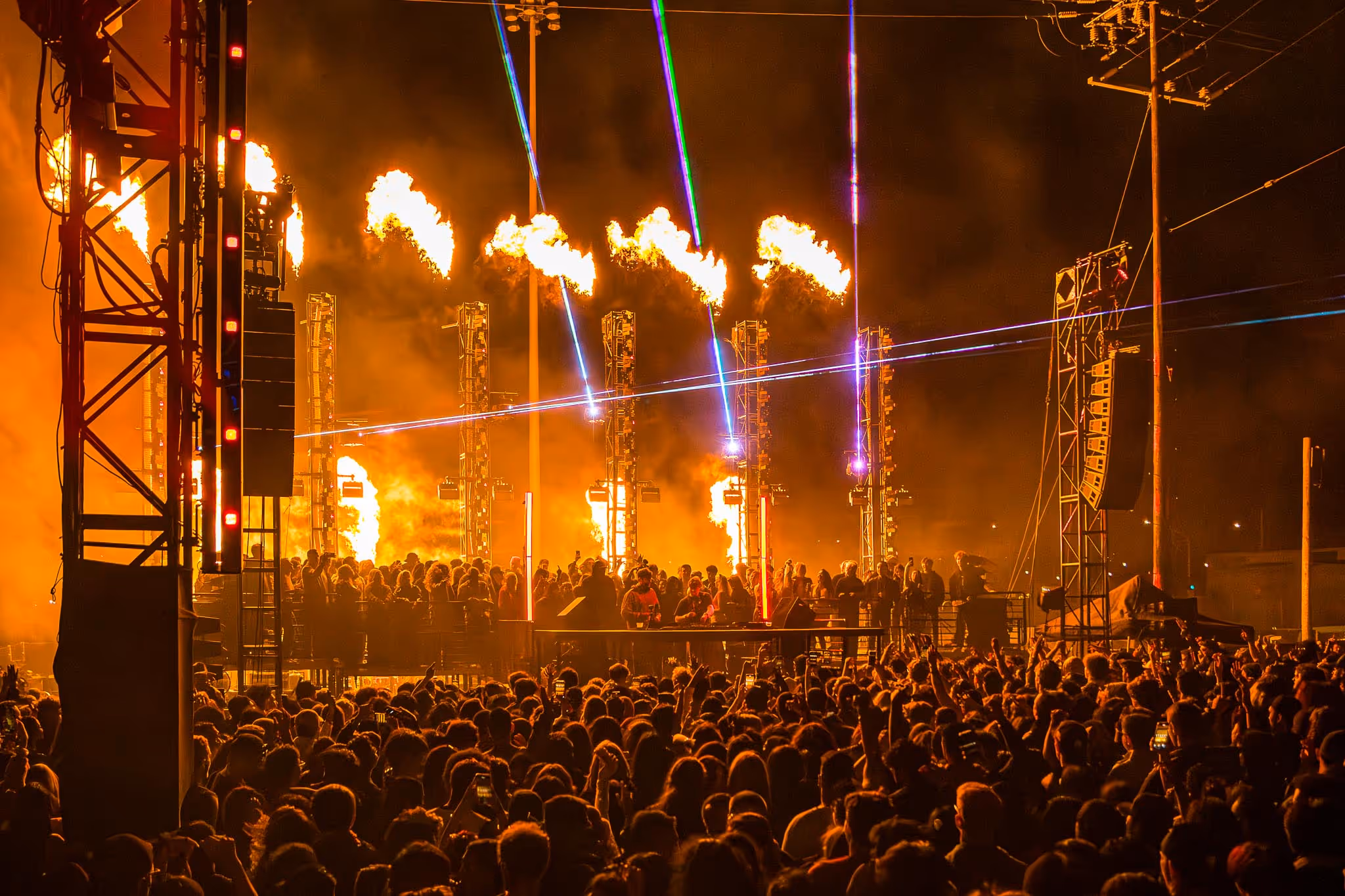 Large crowd watching concert with fire
