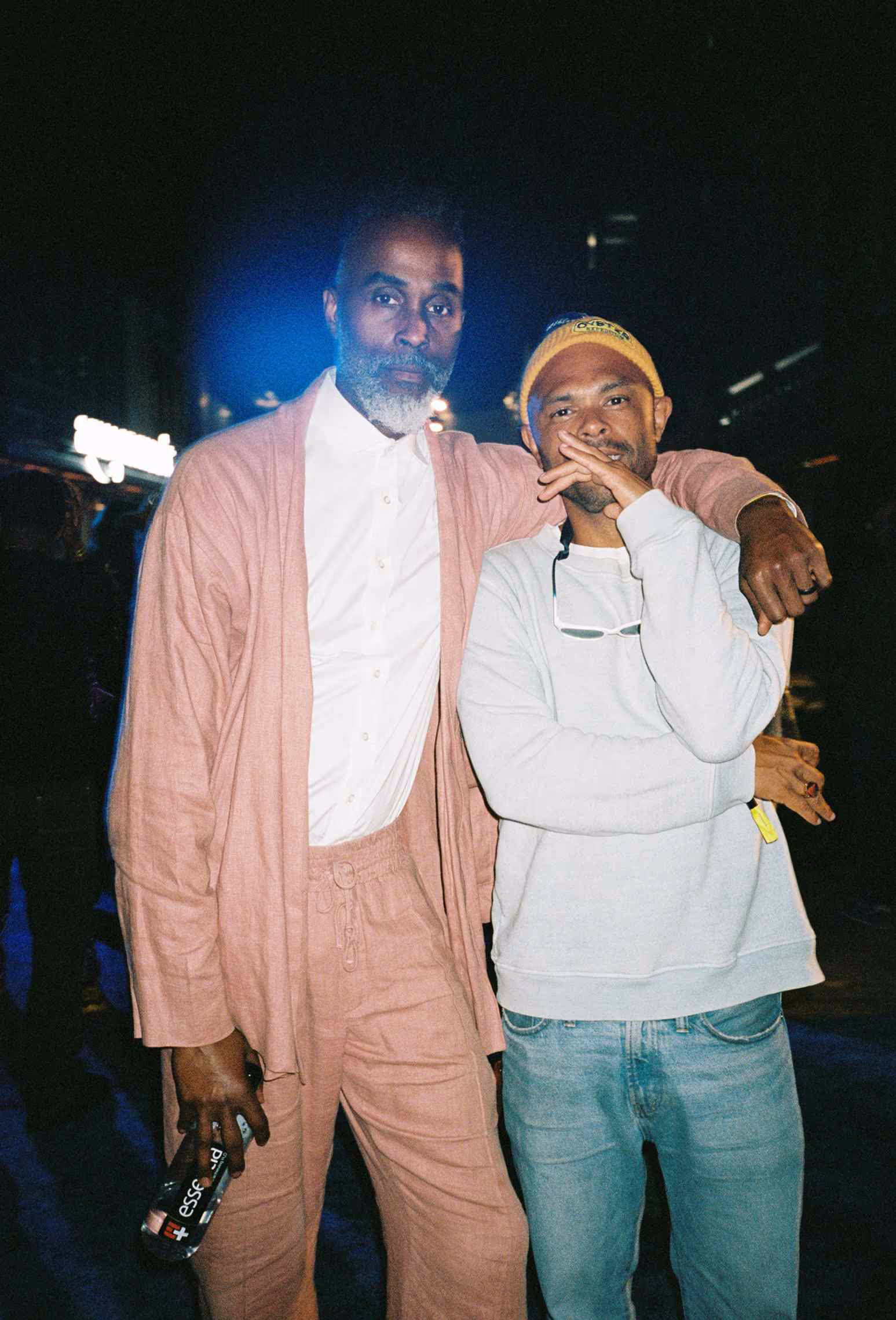 Two men standing next to each other in front of a crowd.