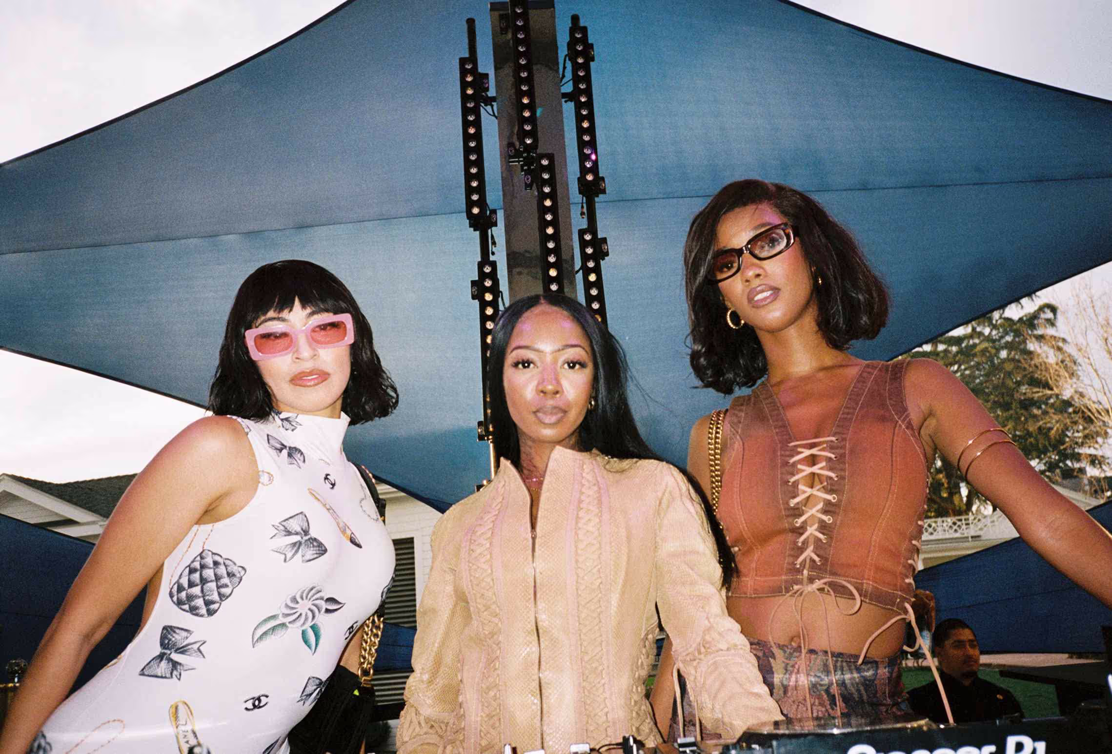A group of three women standing next to each other.