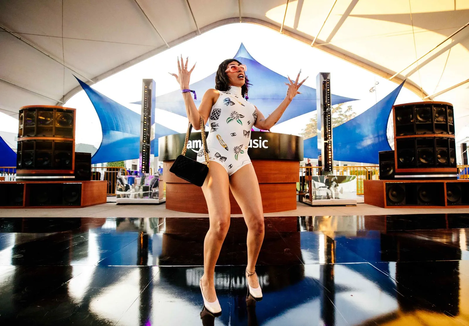 A woman in a bodysuit standing on a stage.