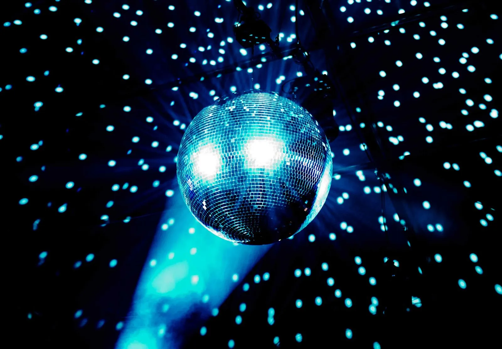 A disco ball hanging from the ceiling in a dark room.