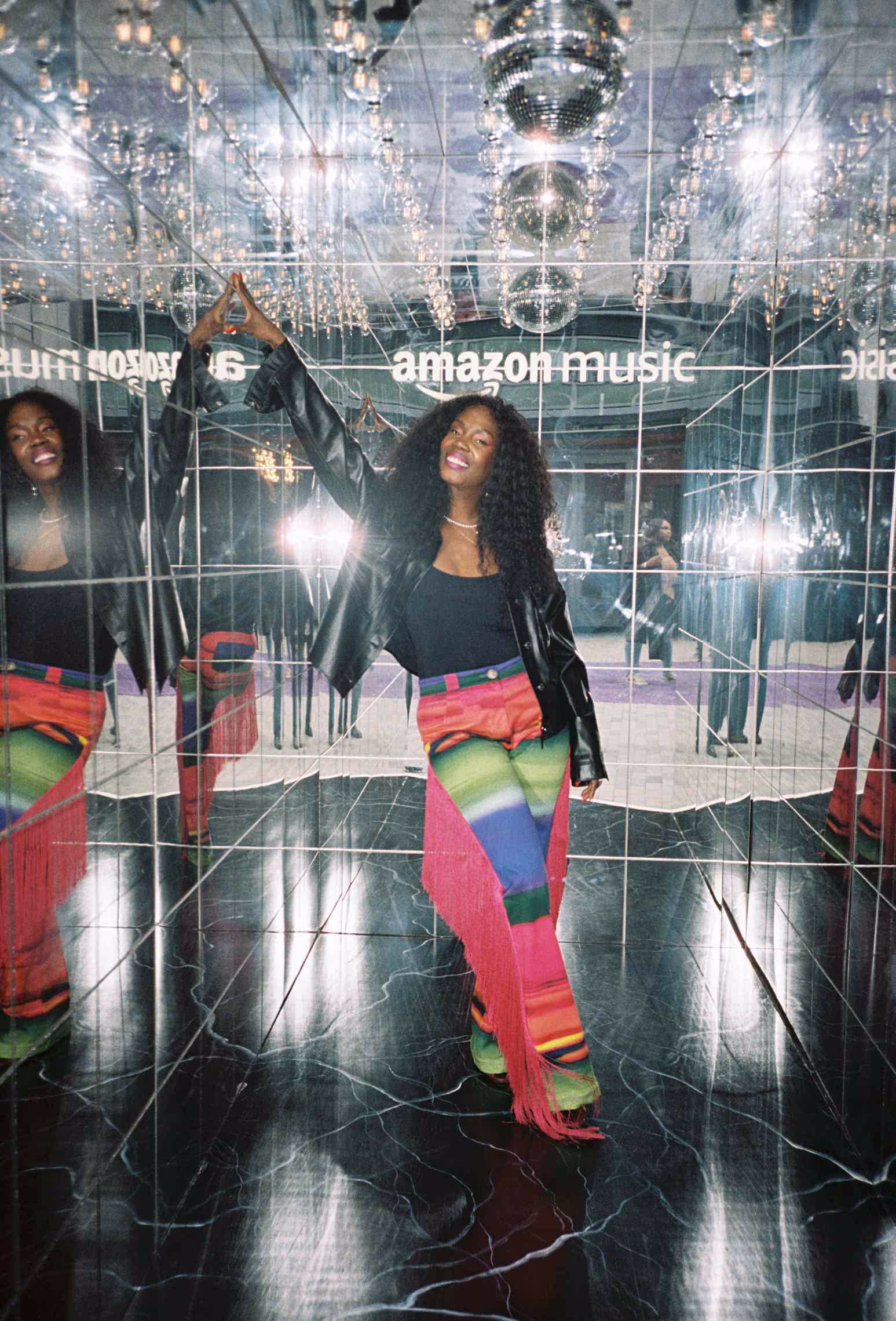 A woman standing in front of a mirror.