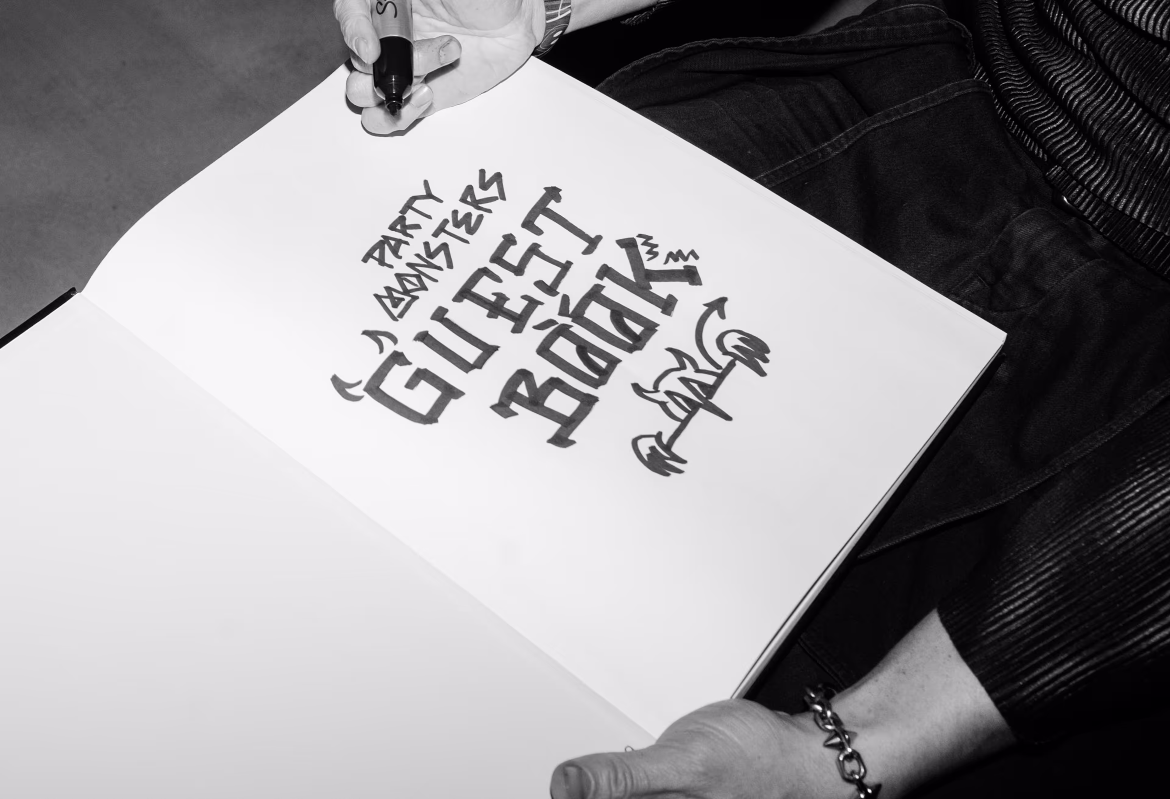 A person holding a piece of paper with writing on it.