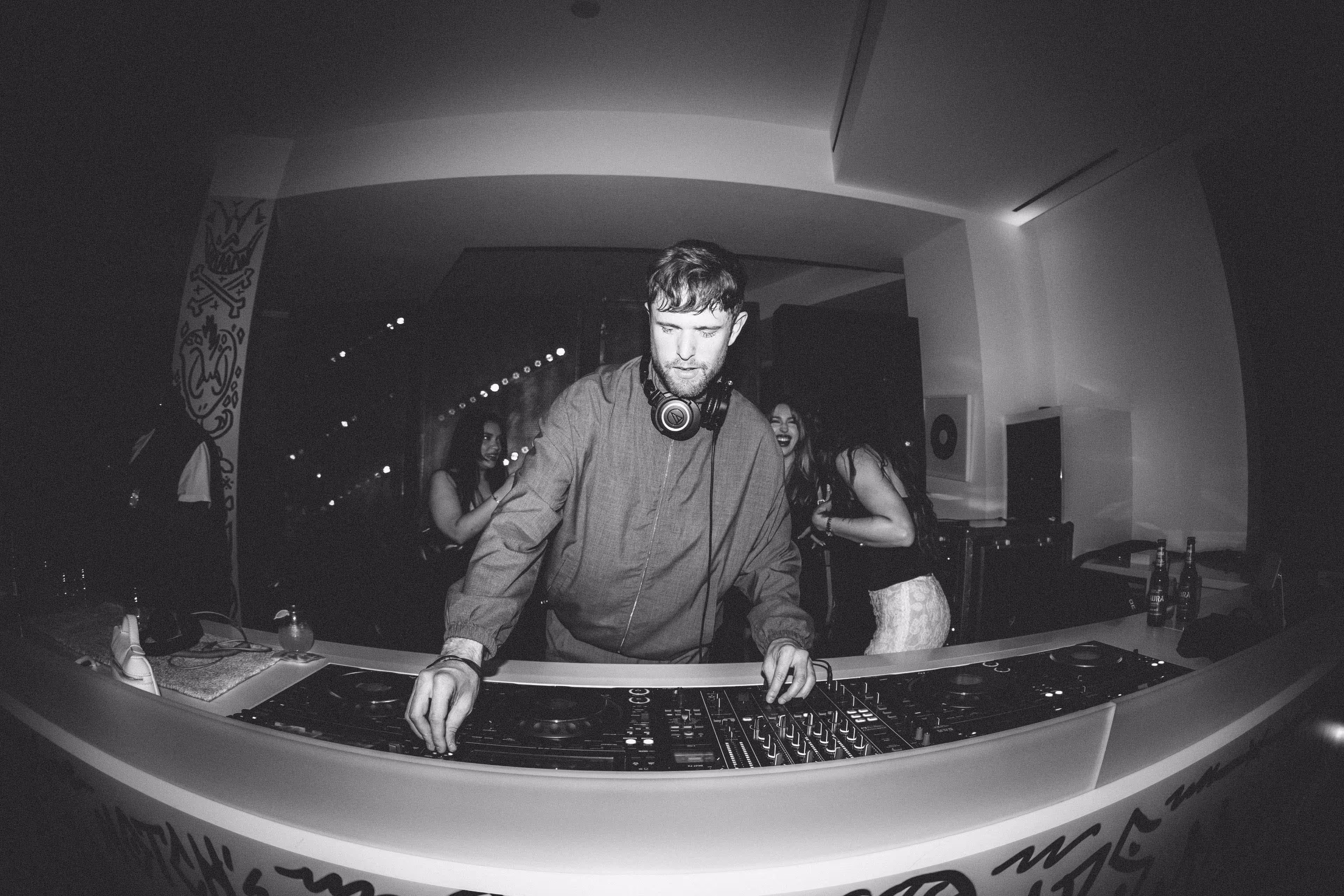 A man in a dj booth with headphones on.