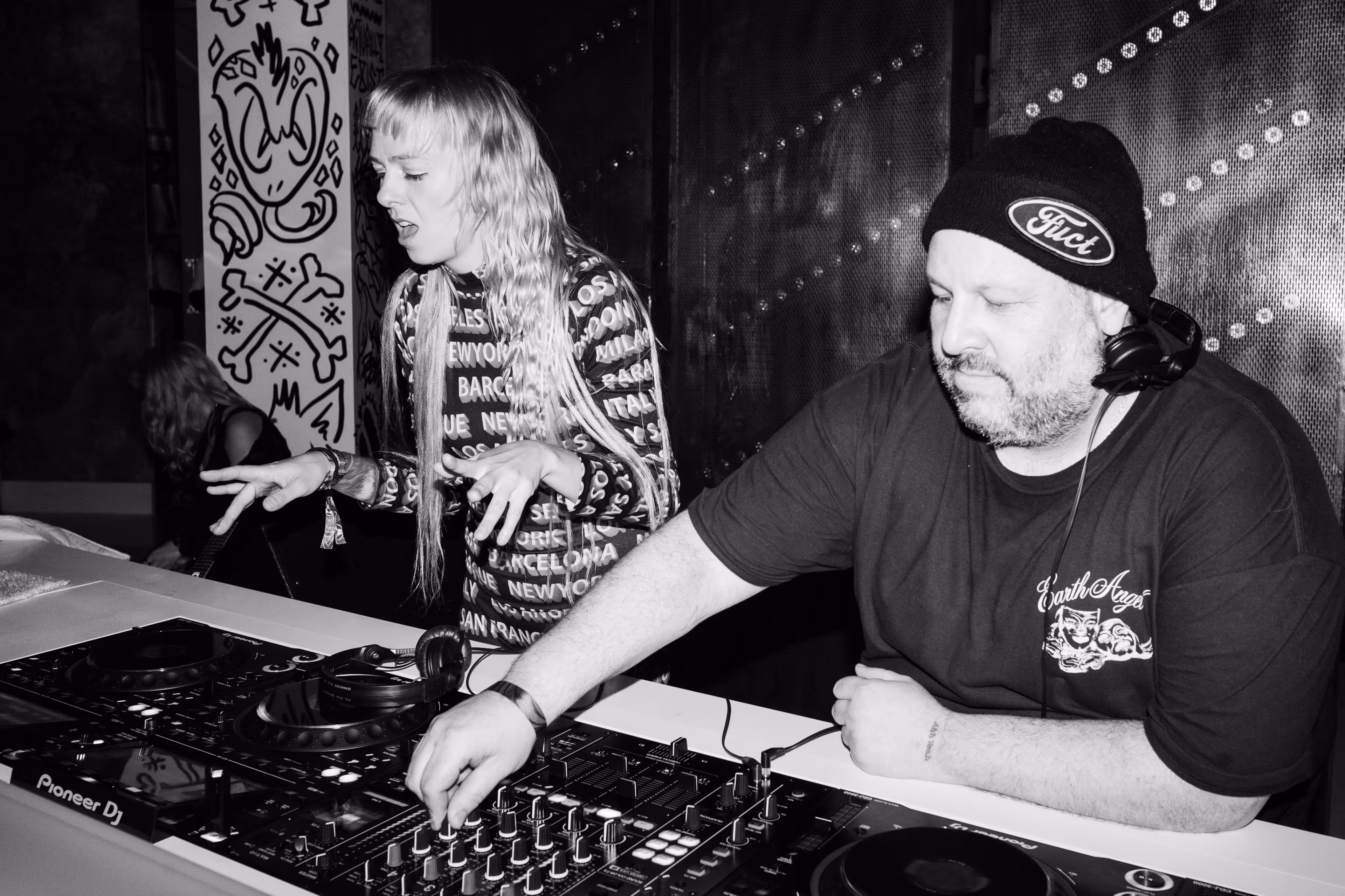 A man and a woman at a dj booth.