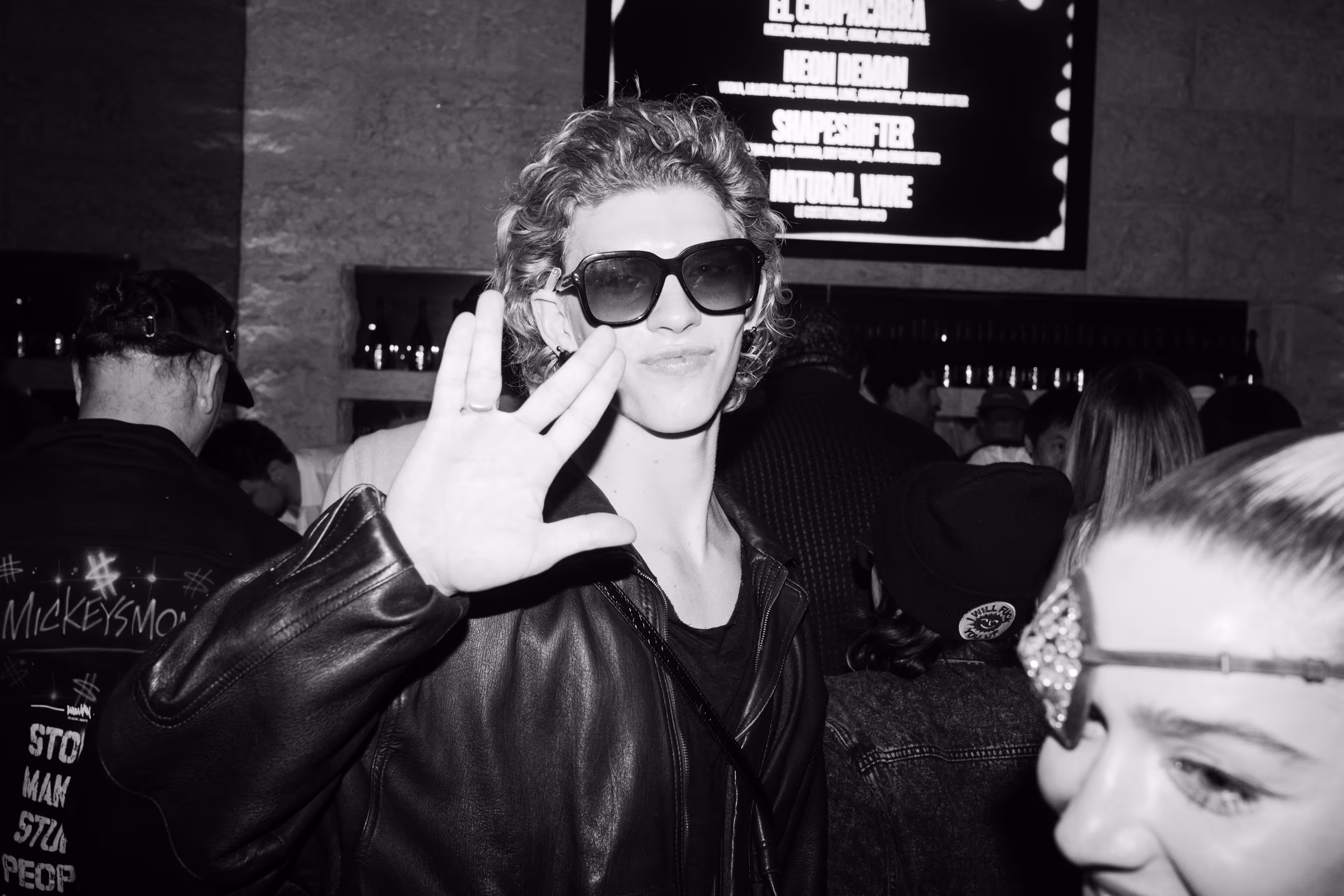 A black and white photo of a woman wearing sunglasses.