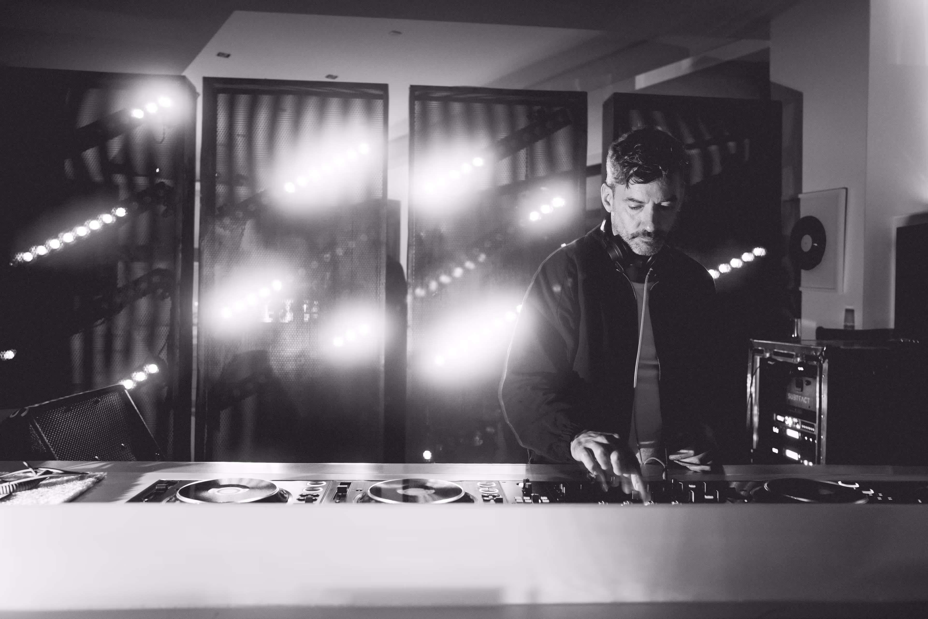 A man standing in front of a mixing desk.