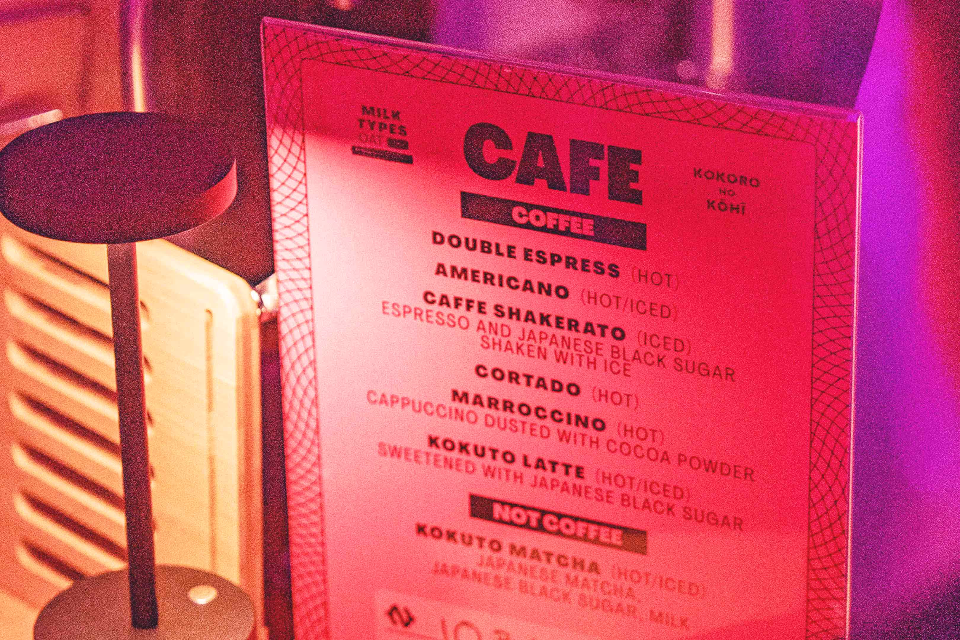 A menu sitting on top of a table next to a heater.