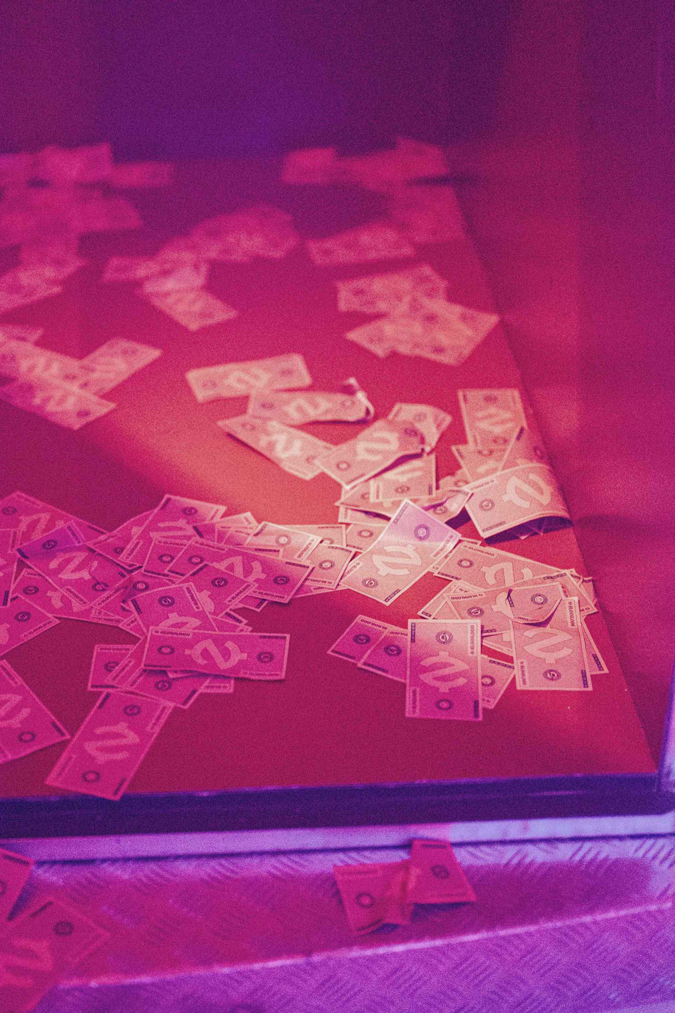 A table topped with lots of cut out money.